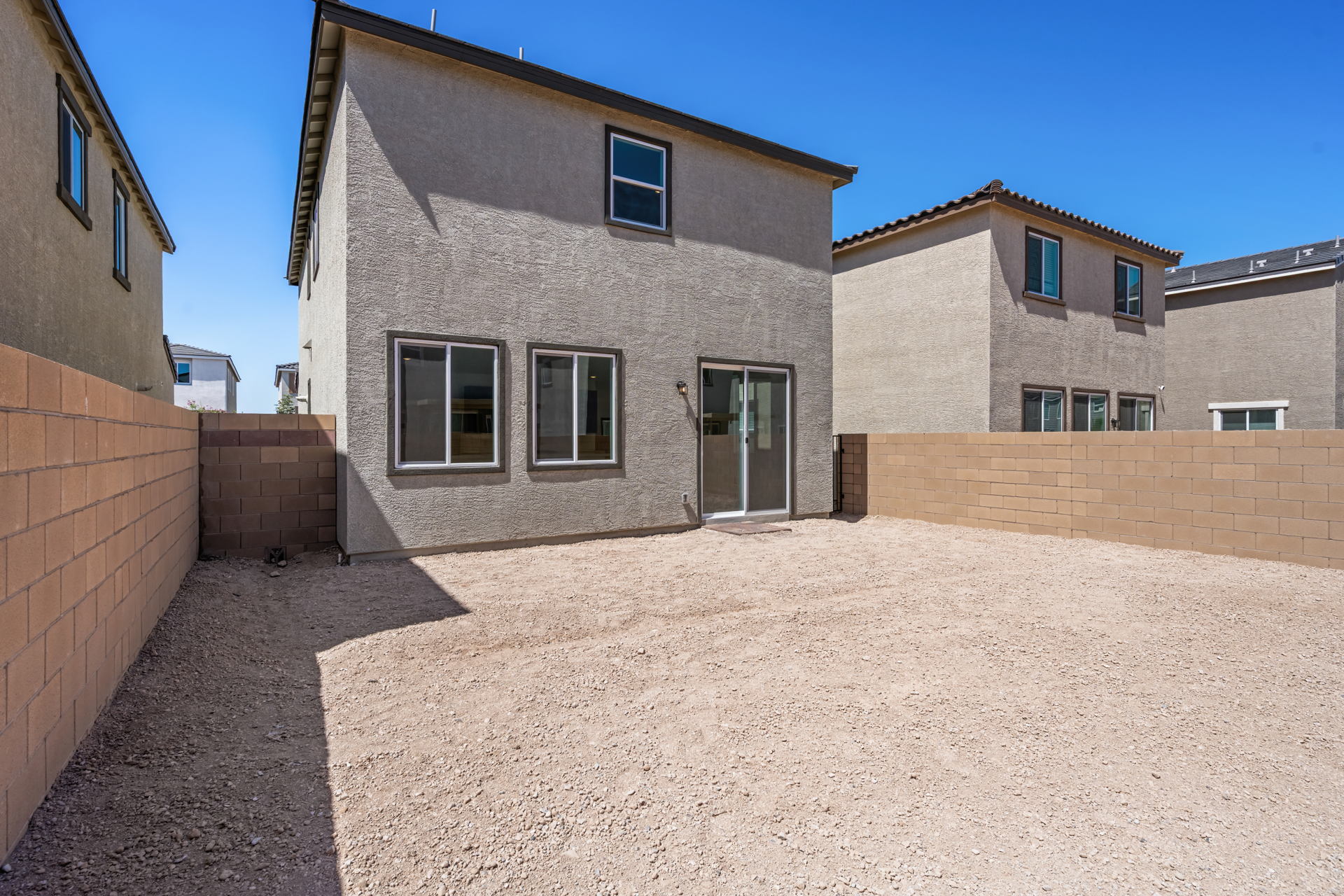A building with a dirt yard.