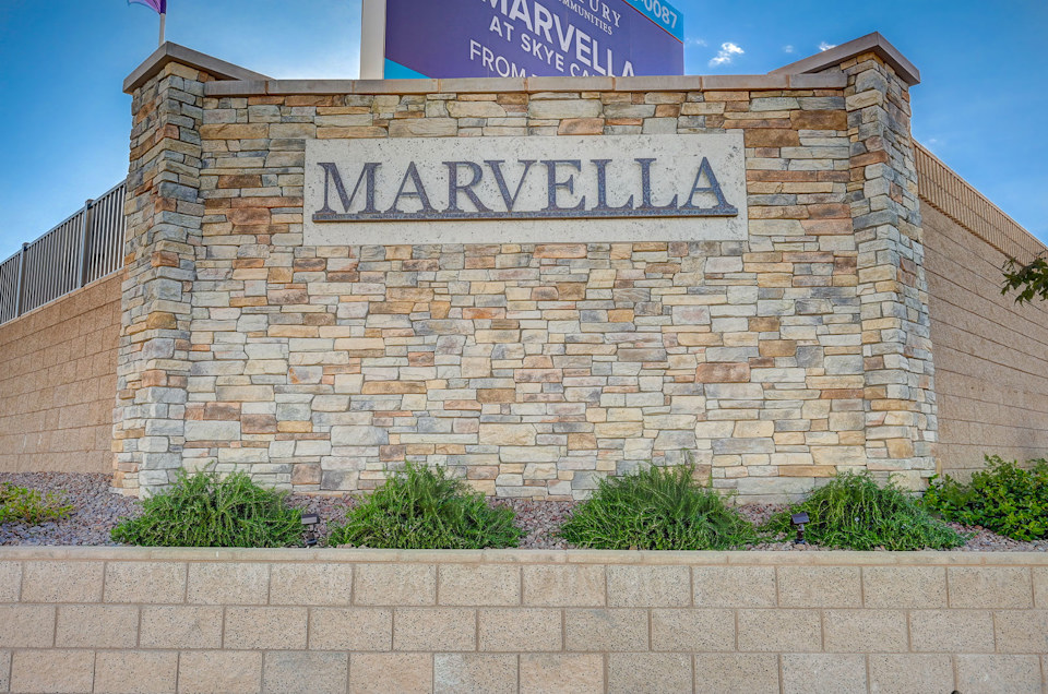 A sign on a brick wall.