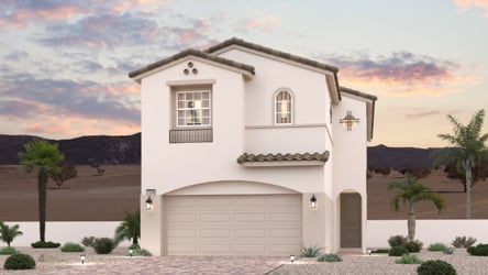A white building with a garage and palm trees.