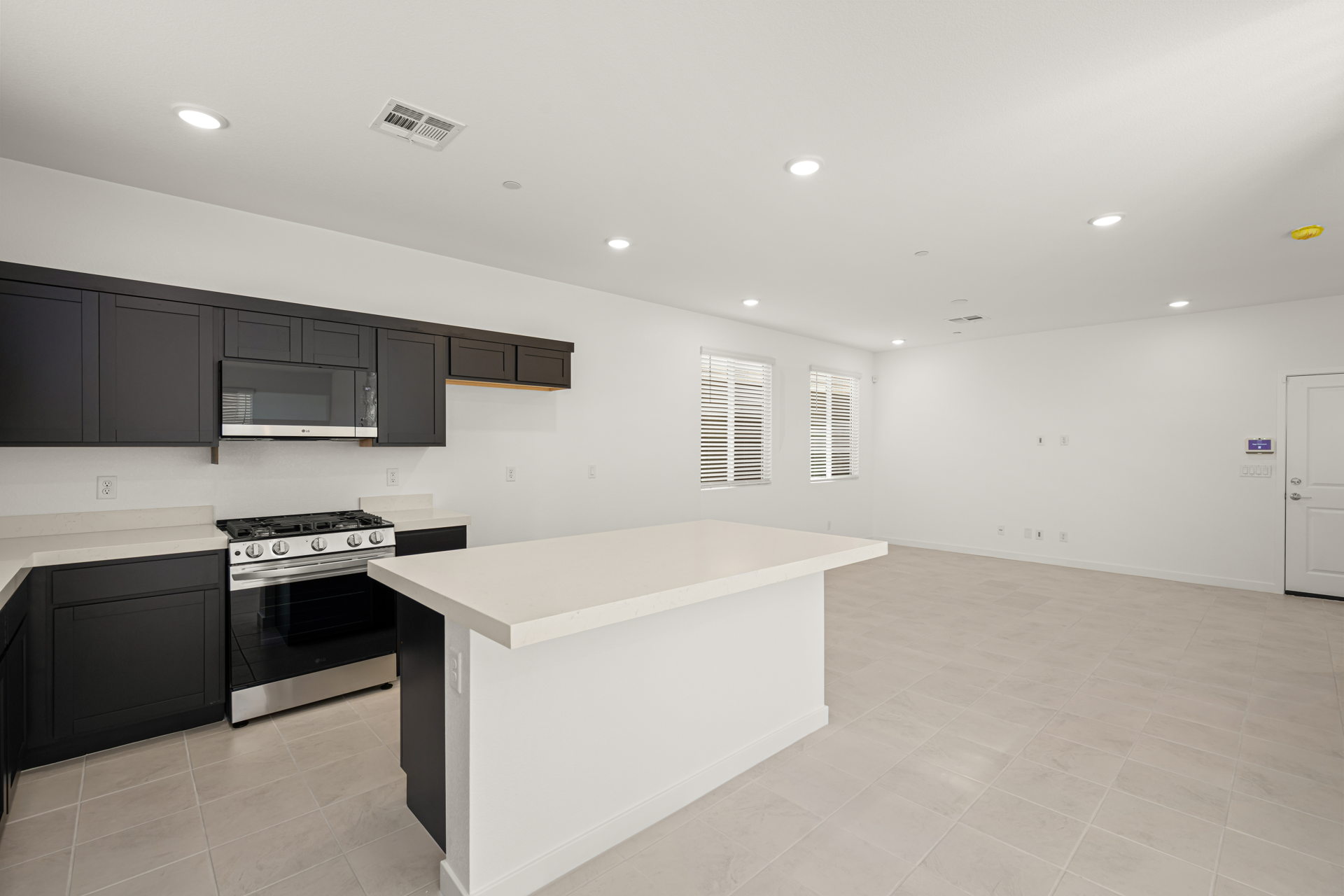A kitchen with black cabinets.