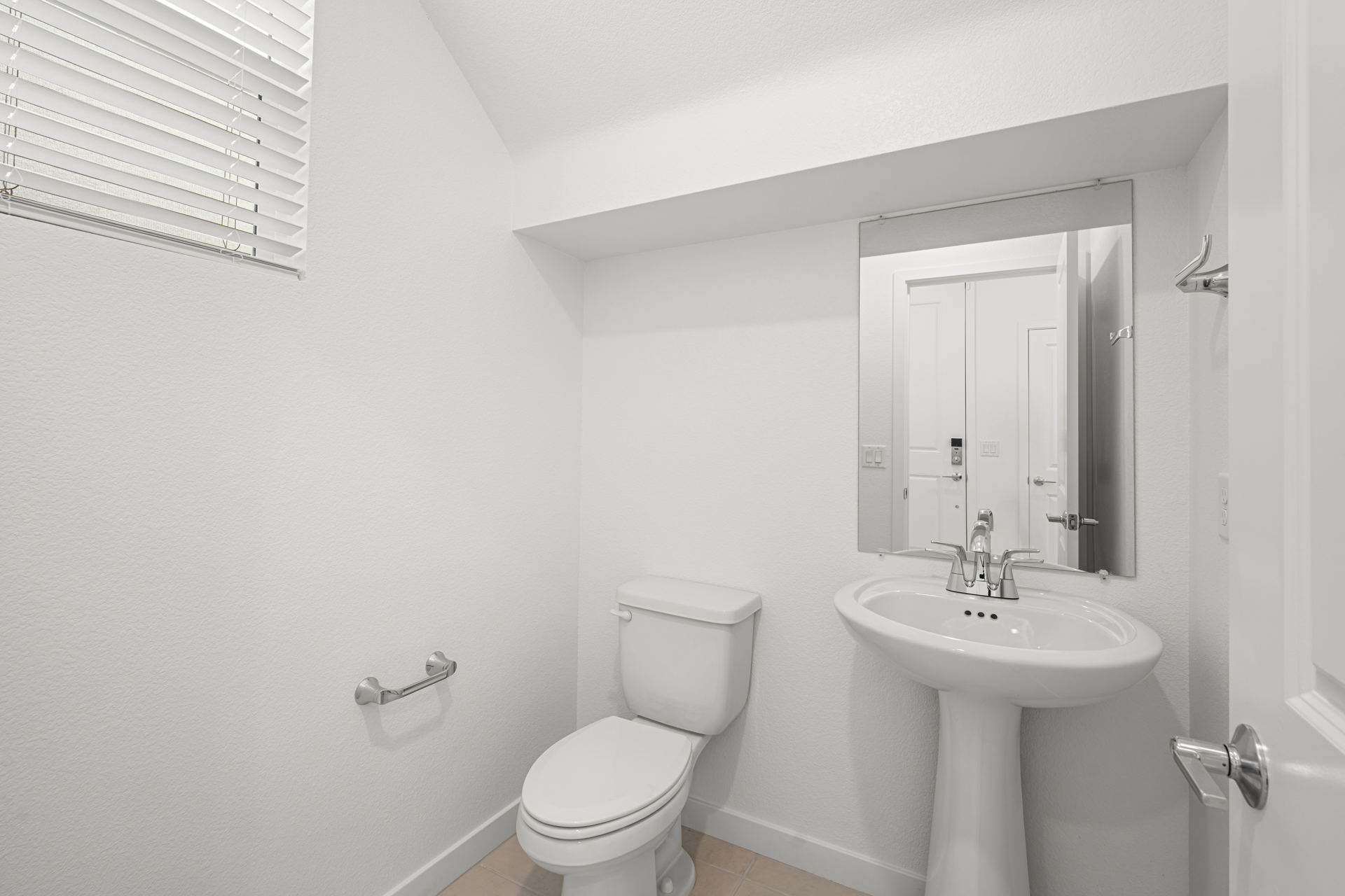 A bathroom with a toilet and sink.