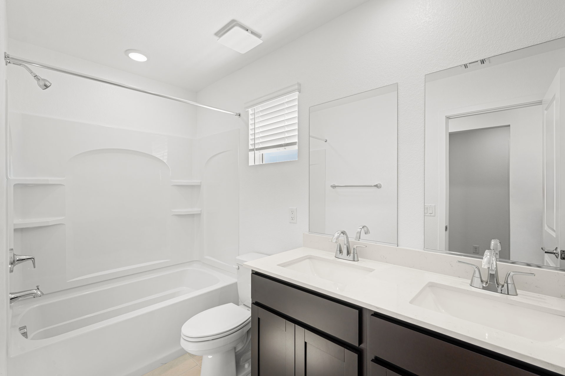 A bathroom with a tub sink and toilet.
