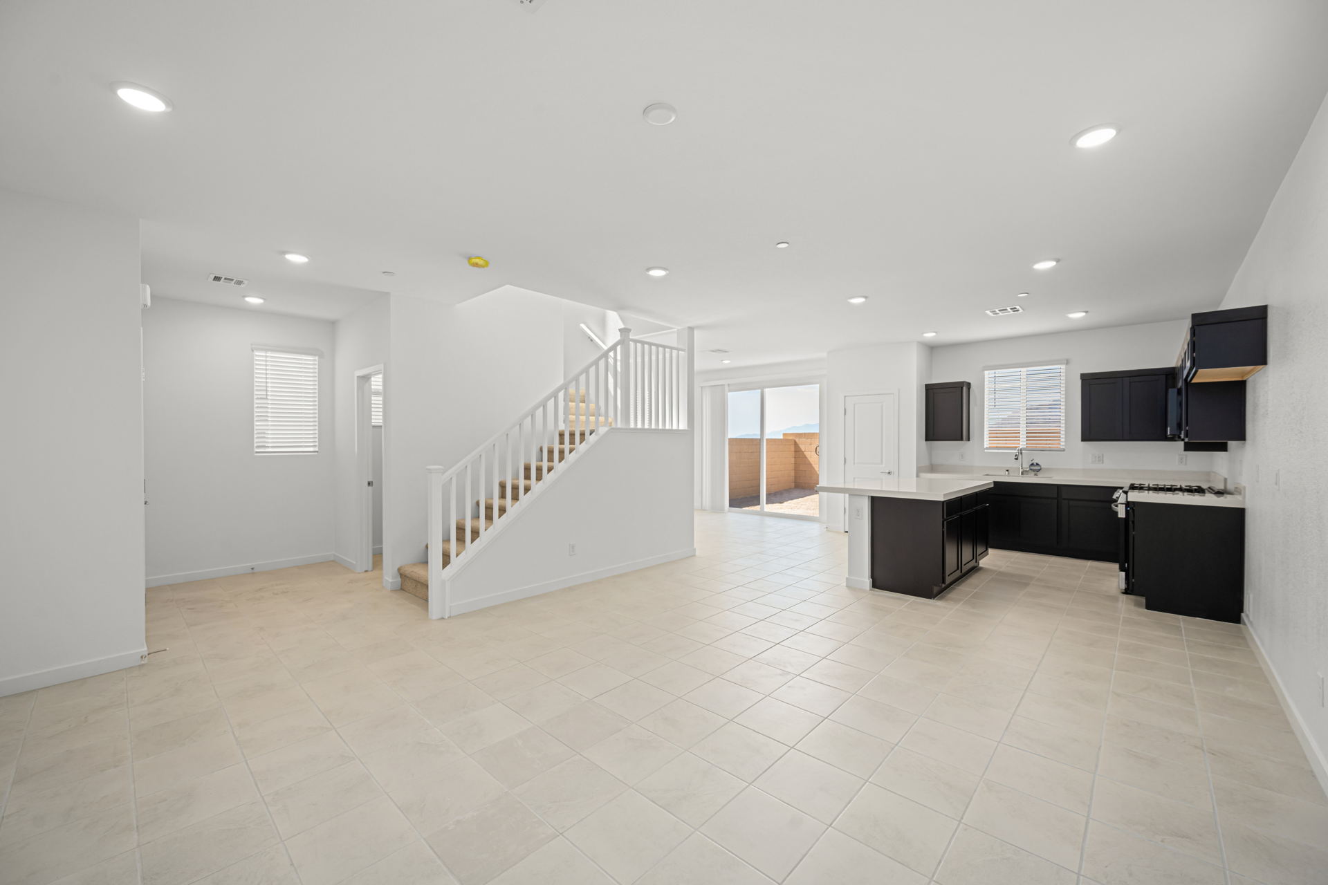 A large white room with a staircase.
