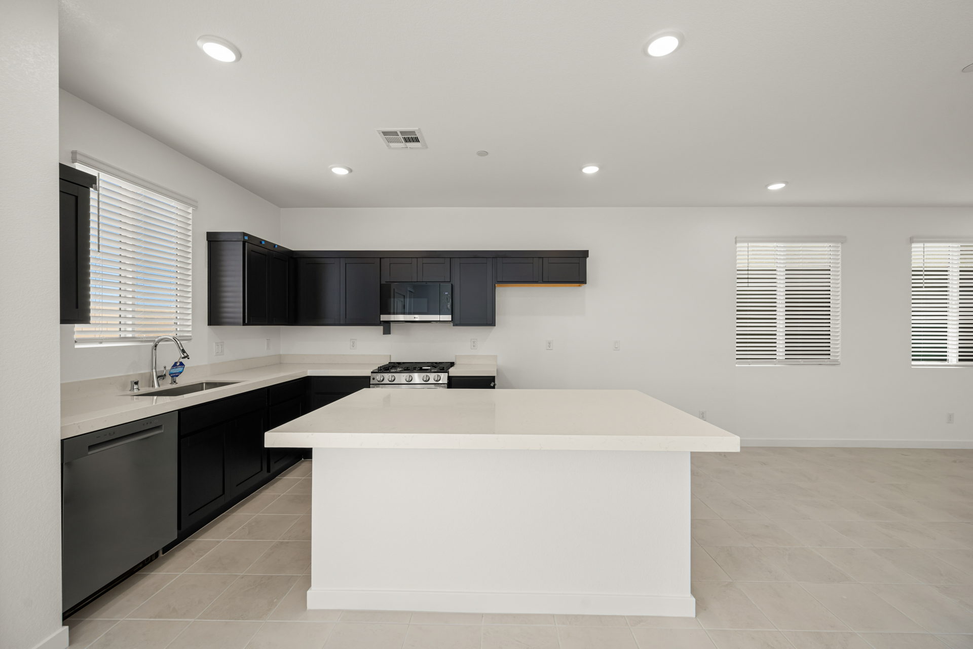 A kitchen with black cabinets.
