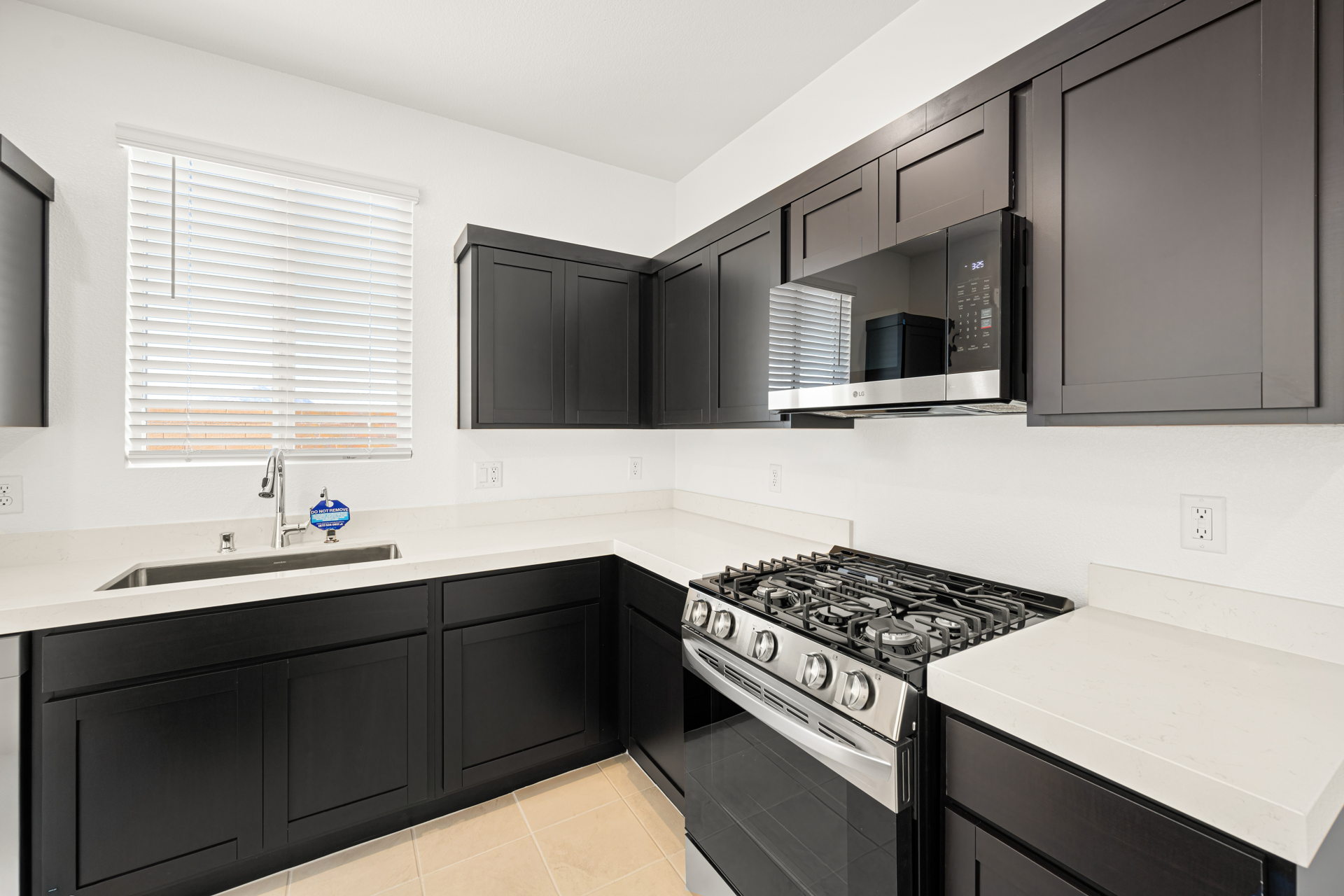 A kitchen with black cabinets.