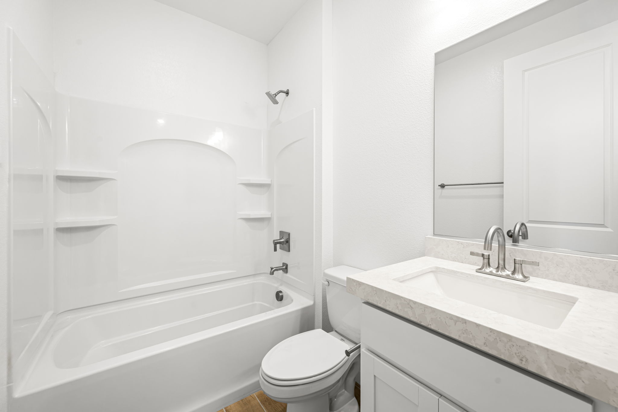 A bathroom with a tub sink and toilet.