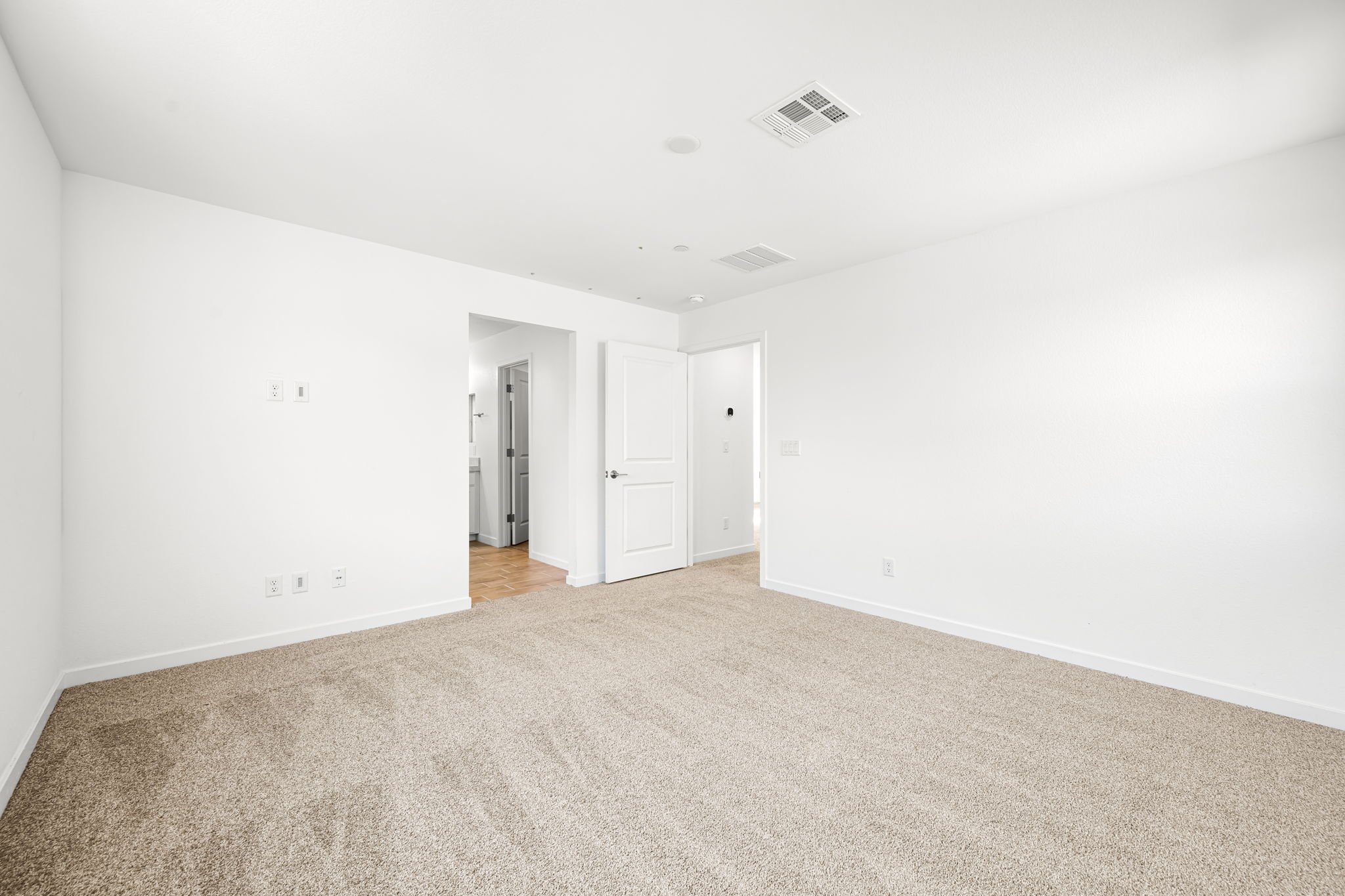 A long hallway with white walls.