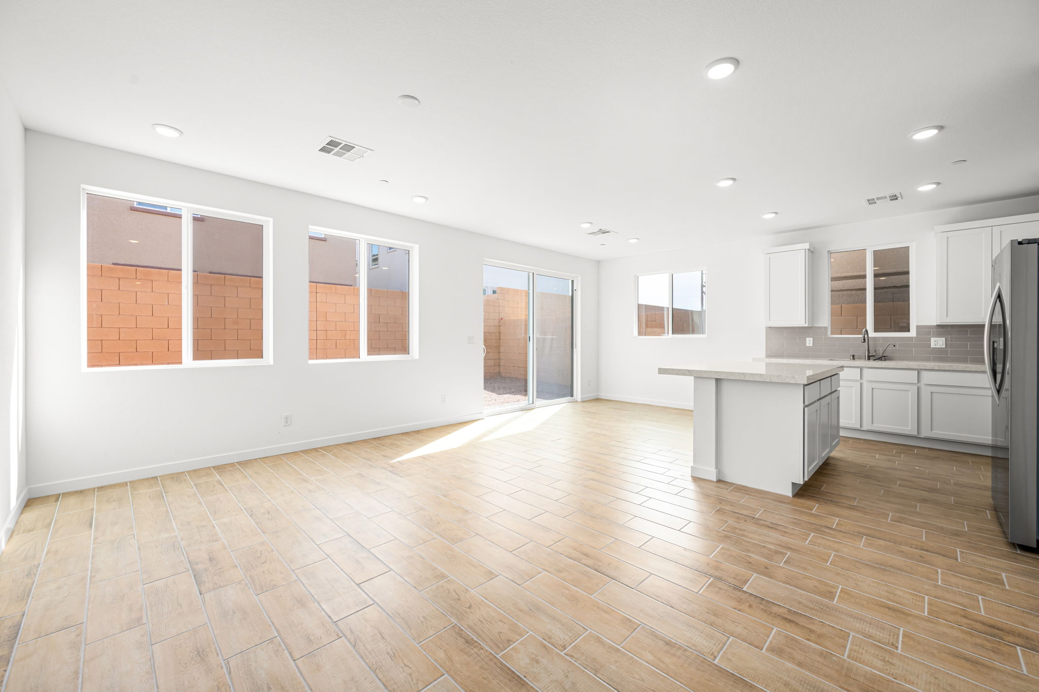 A kitchen with white cabinets.