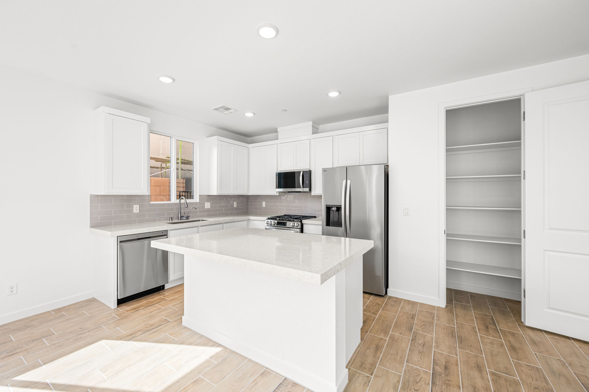 A kitchen with white cabinets.