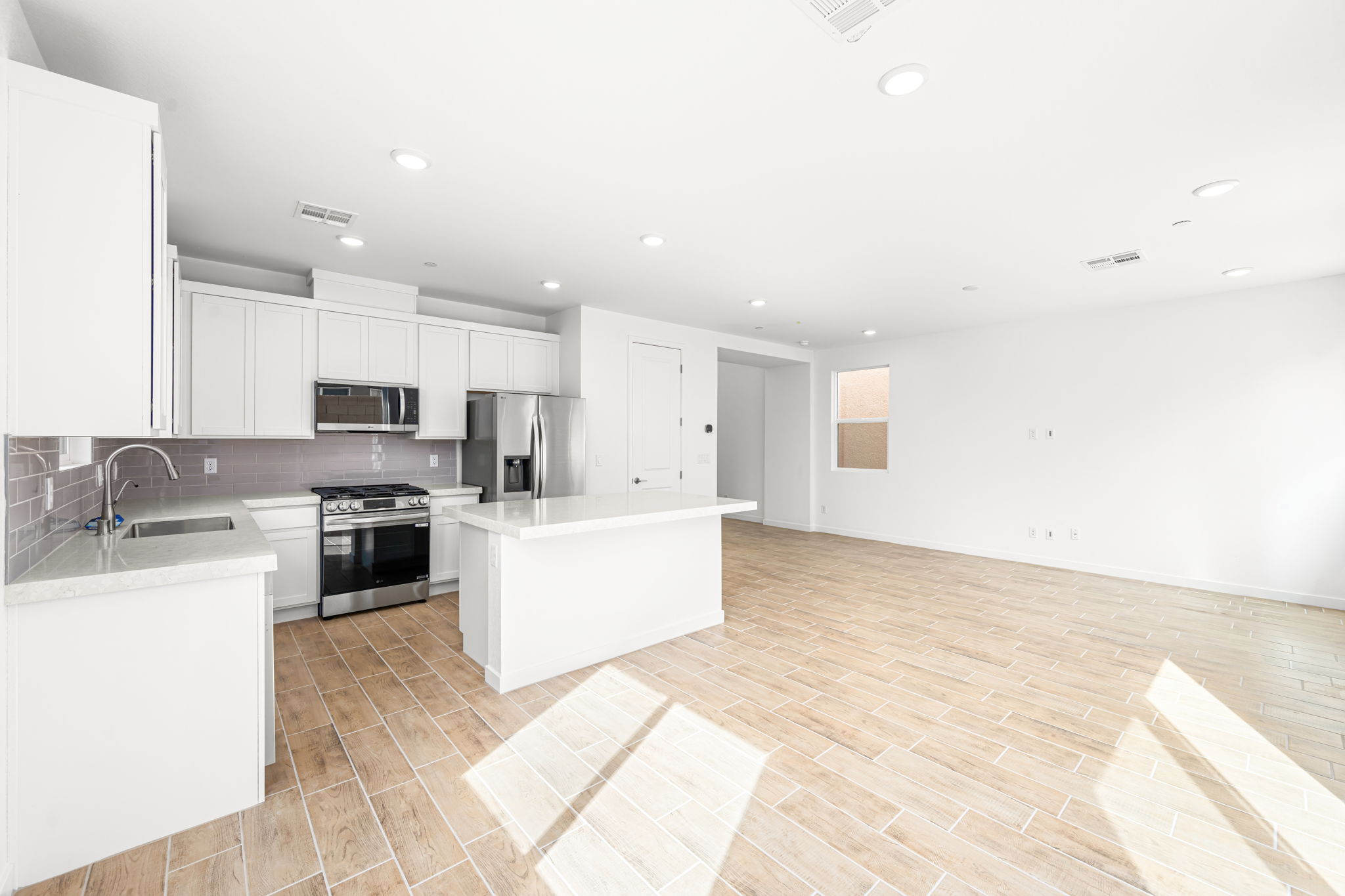 A kitchen with white cabinets.