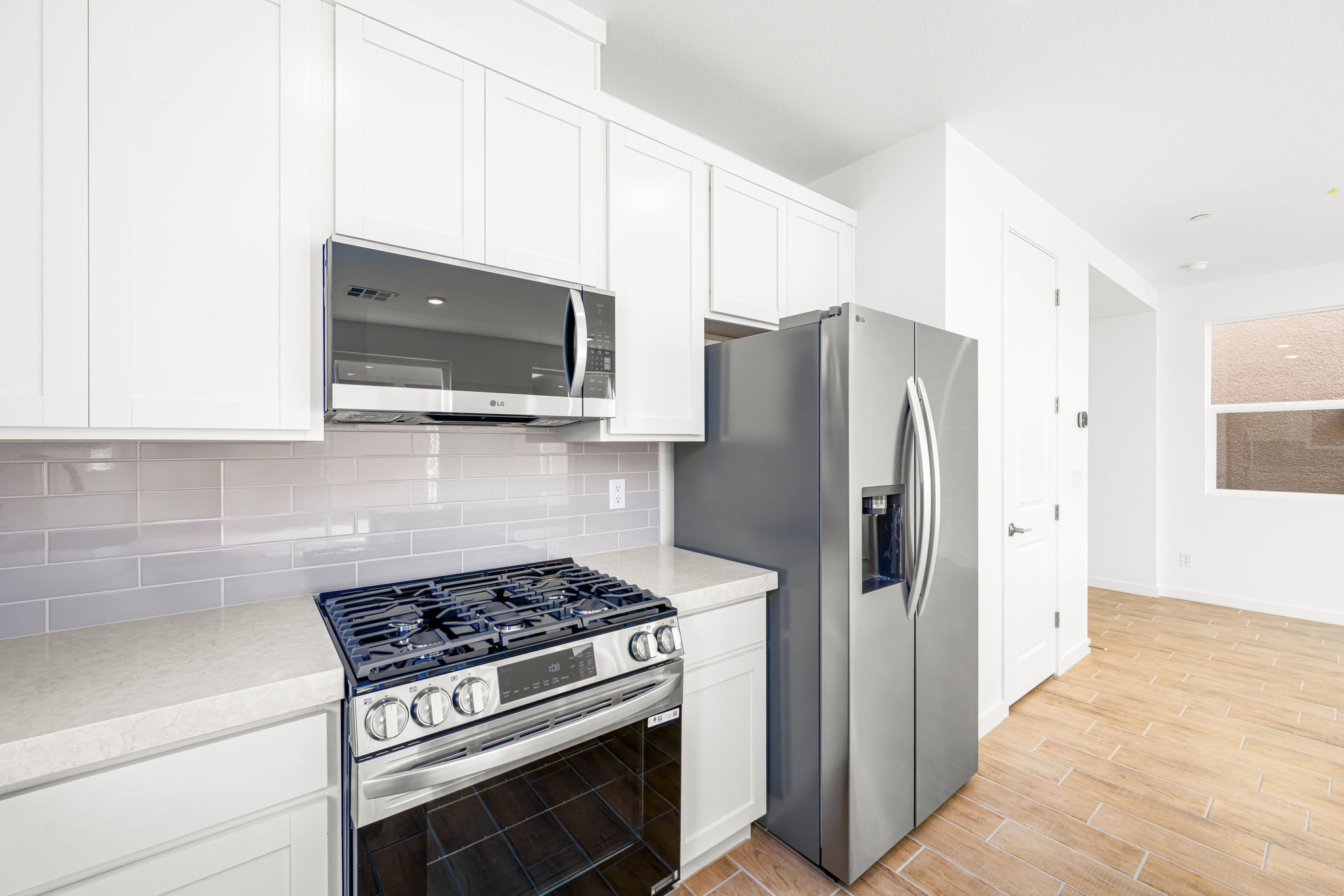 A kitchen with white cabinets.