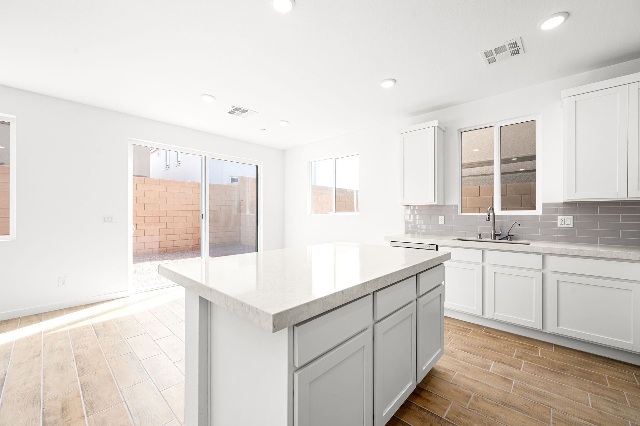 A kitchen with white cabinets.