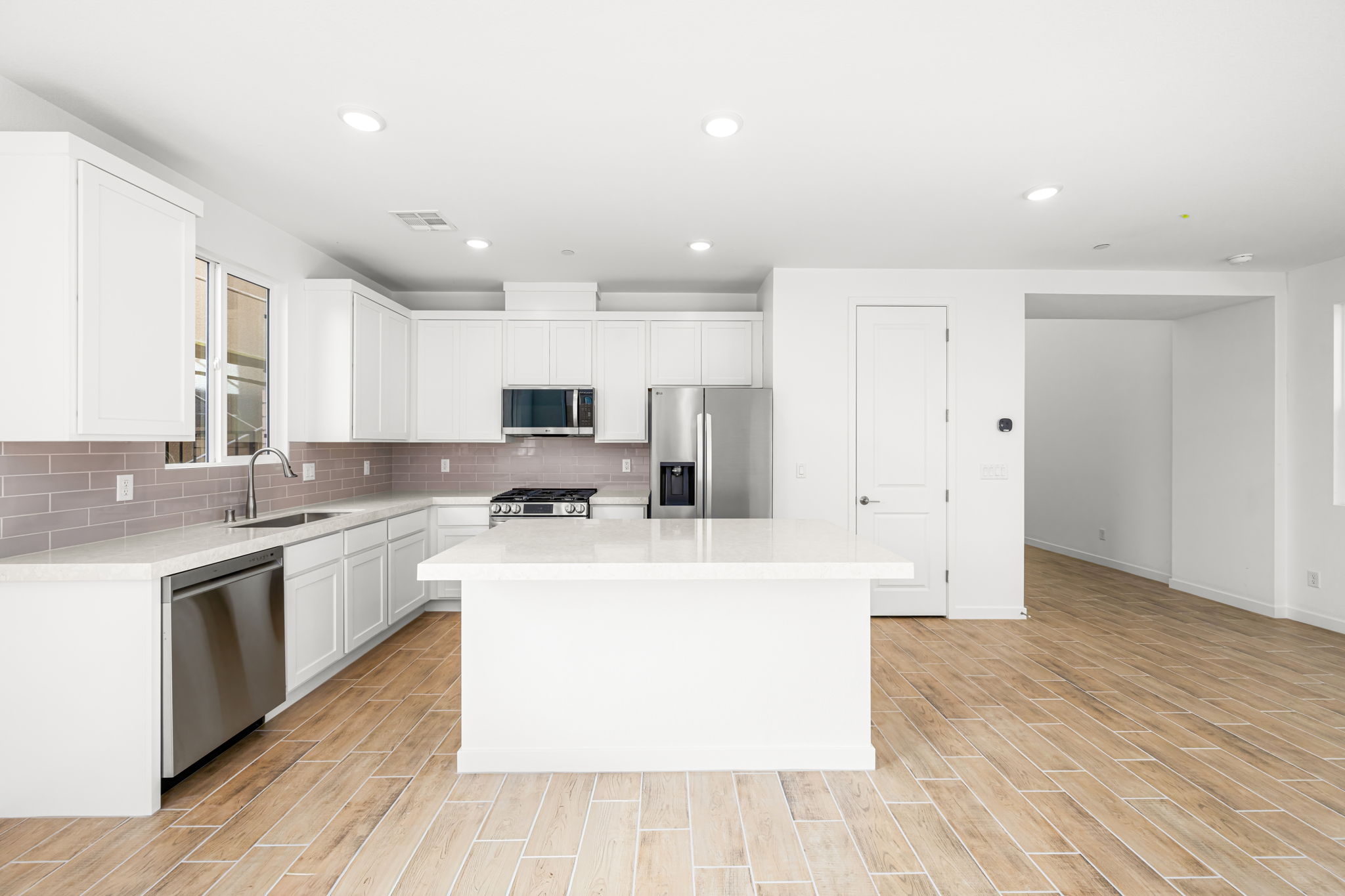 A kitchen with white cabinets.