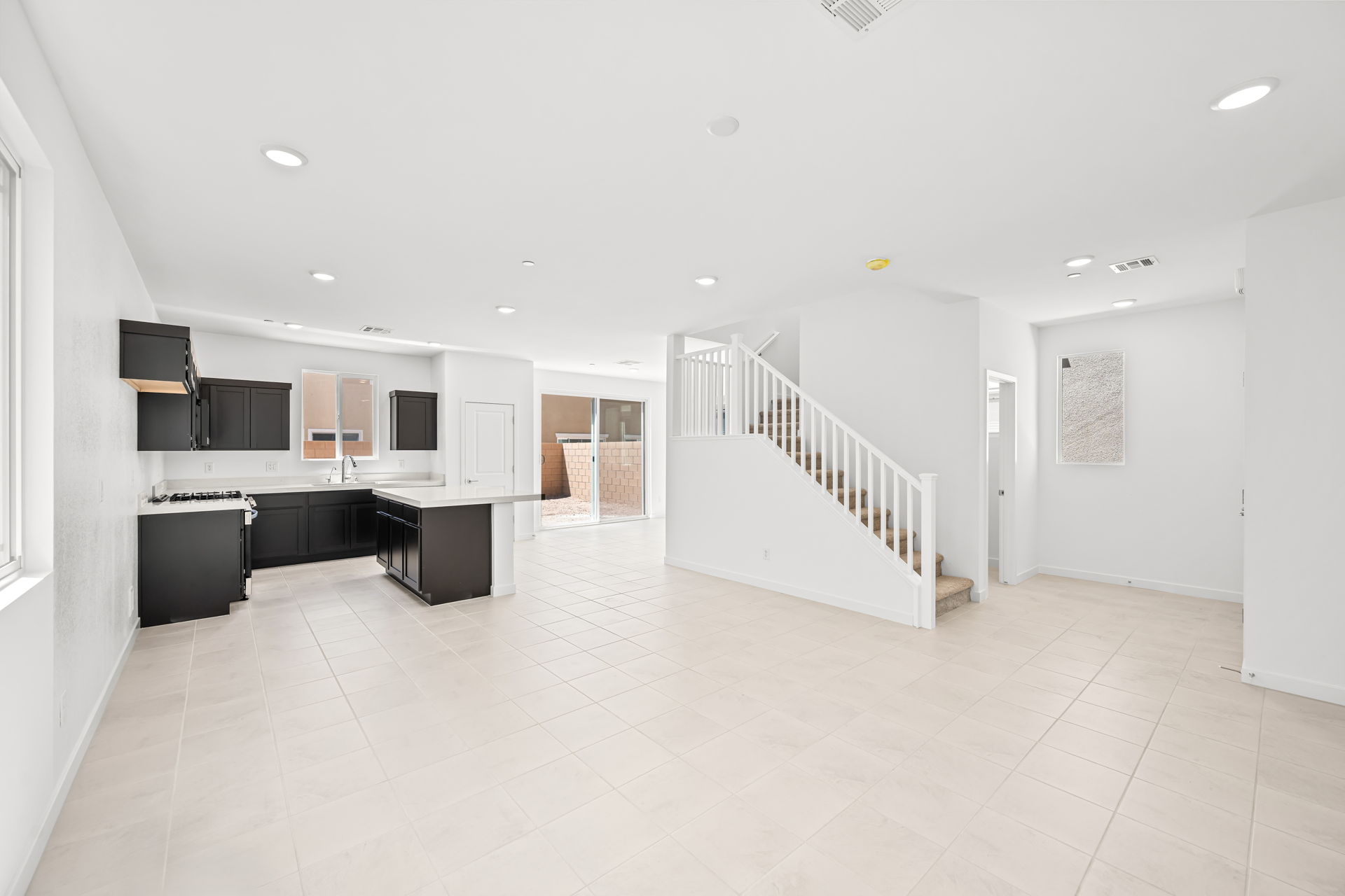 A large white room with a staircase.