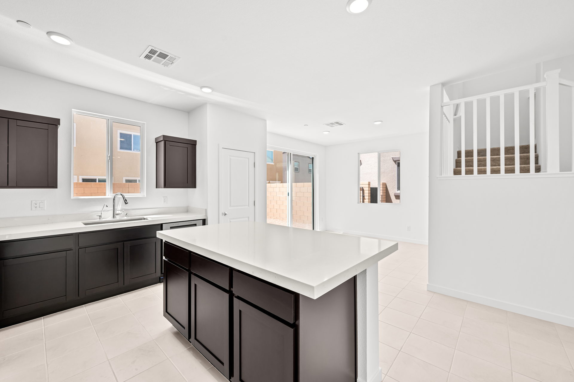 A kitchen with white cabinets.