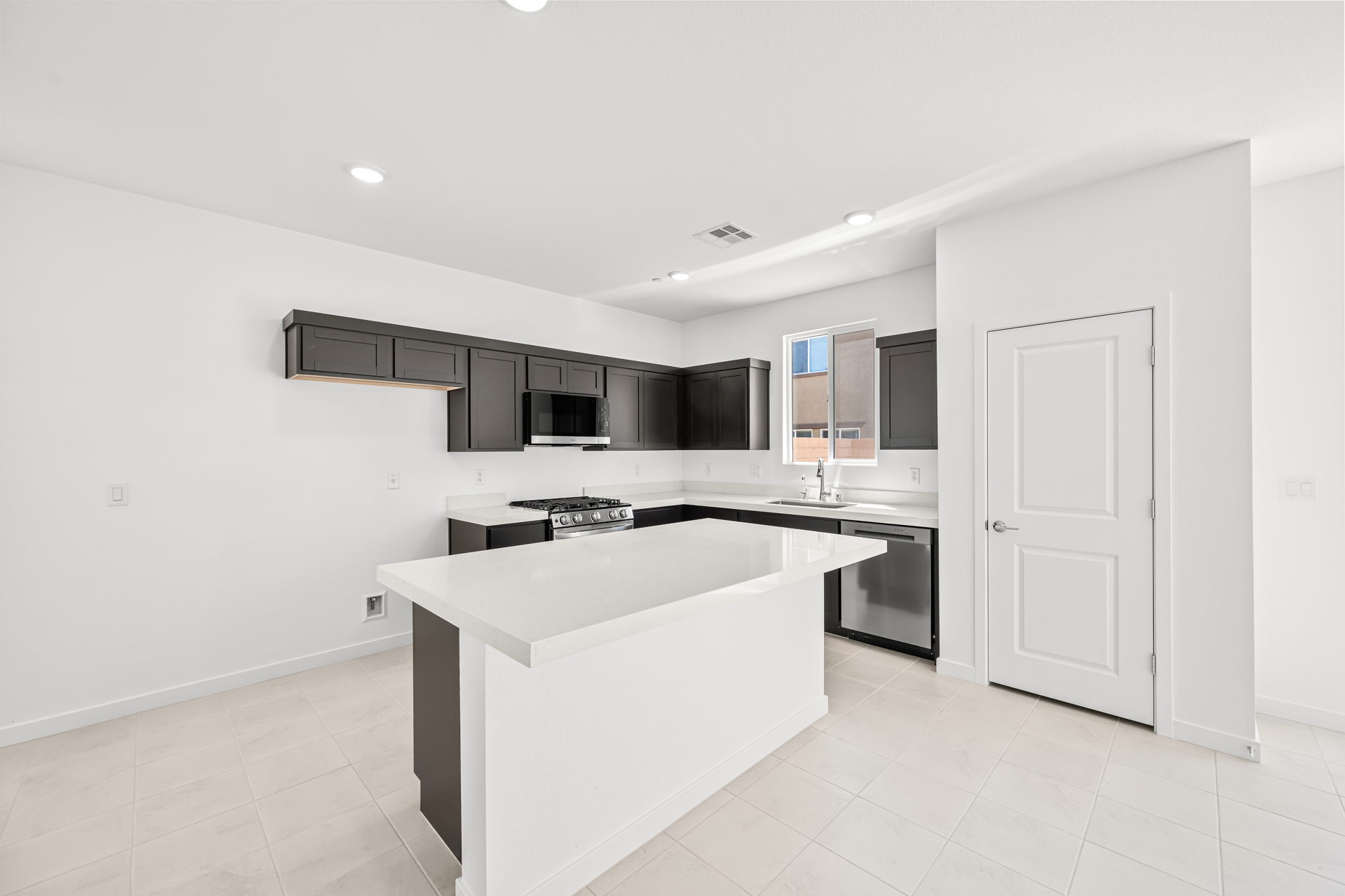A kitchen with a white counter top.