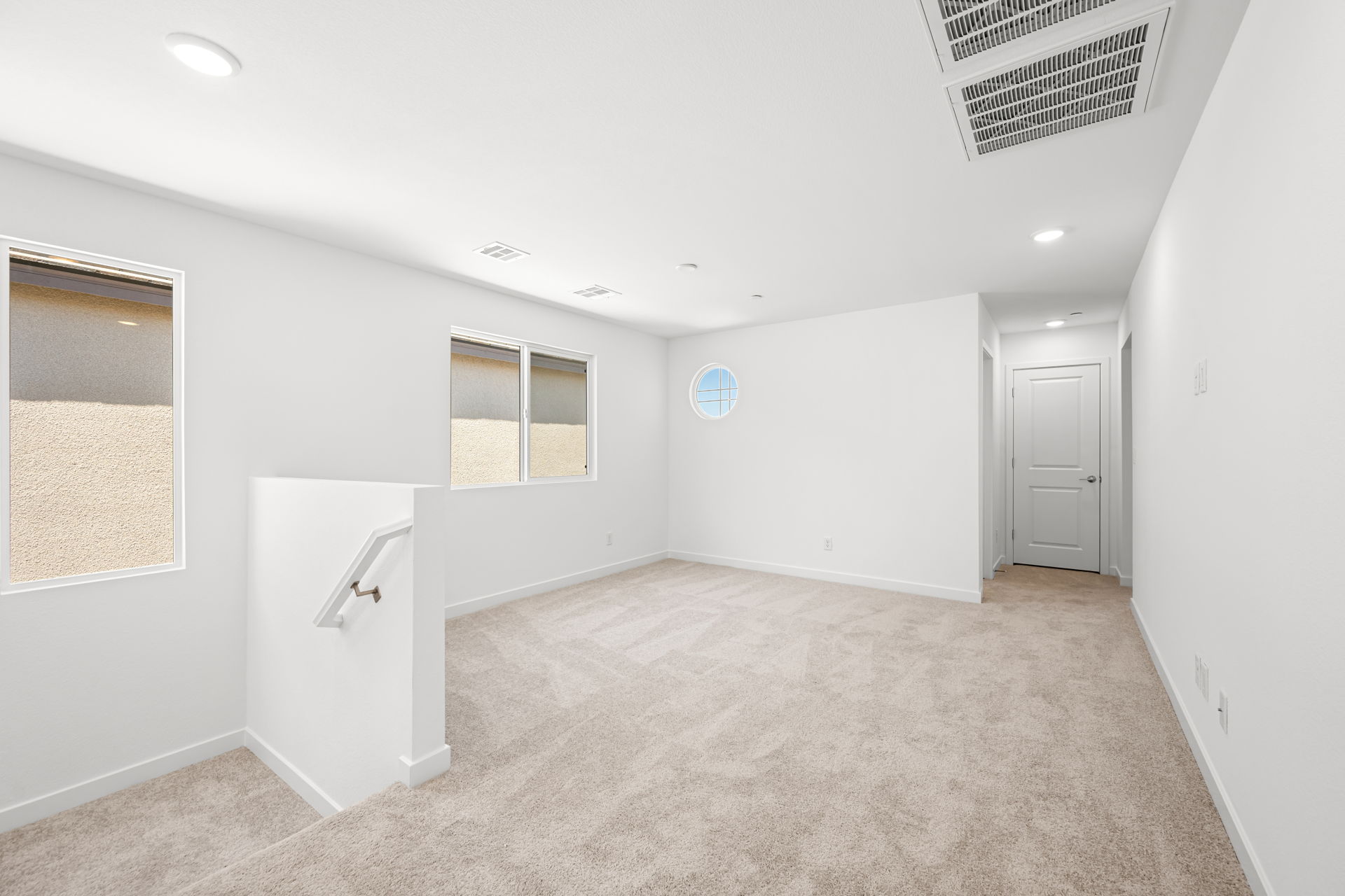A room with white walls and a carpeted floor.