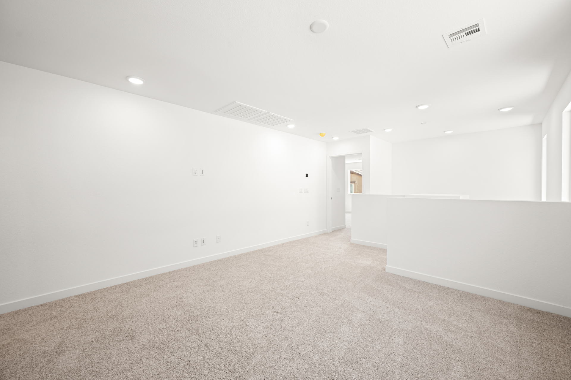 A long hallway with white walls.