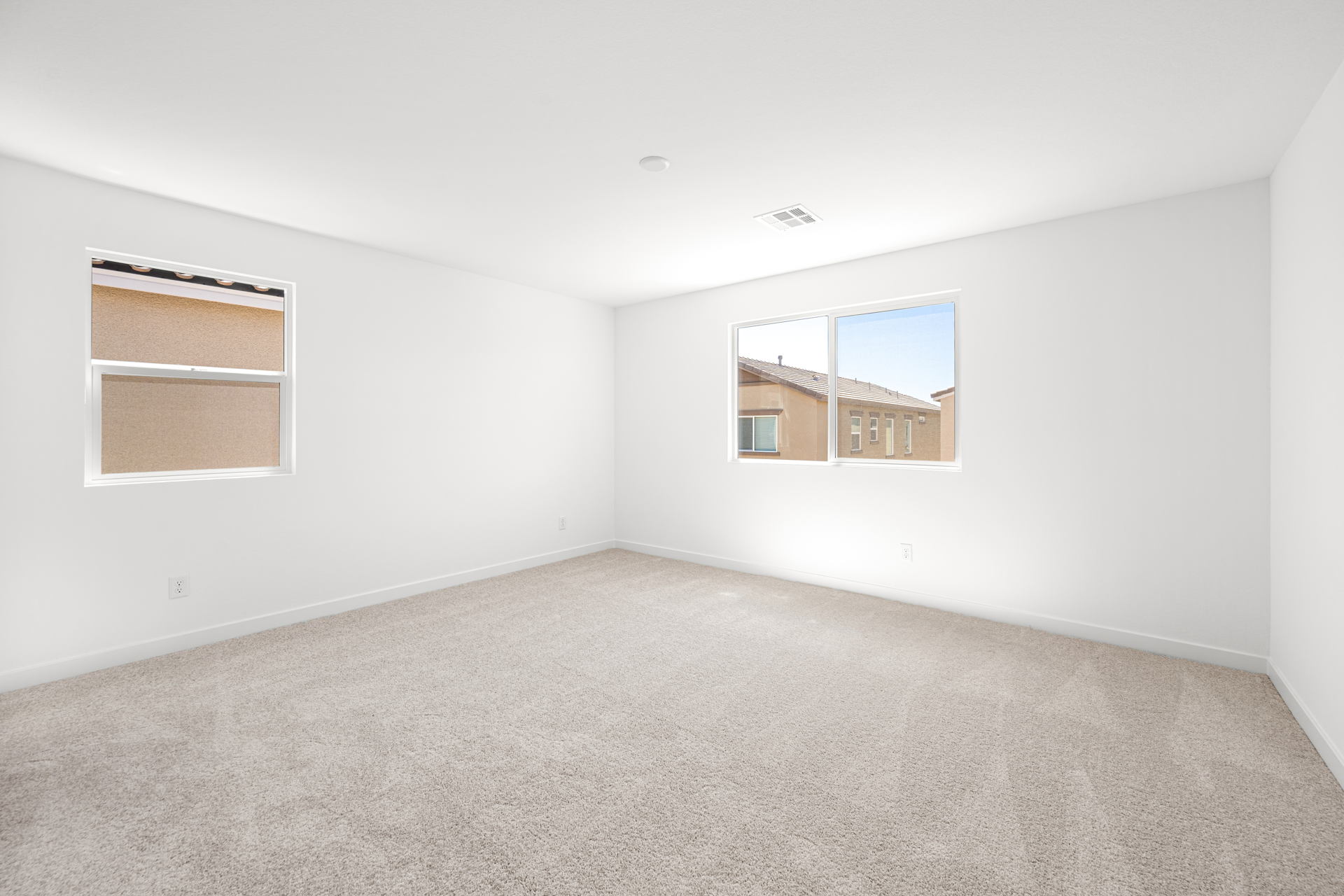 A room with a window and a carpet.