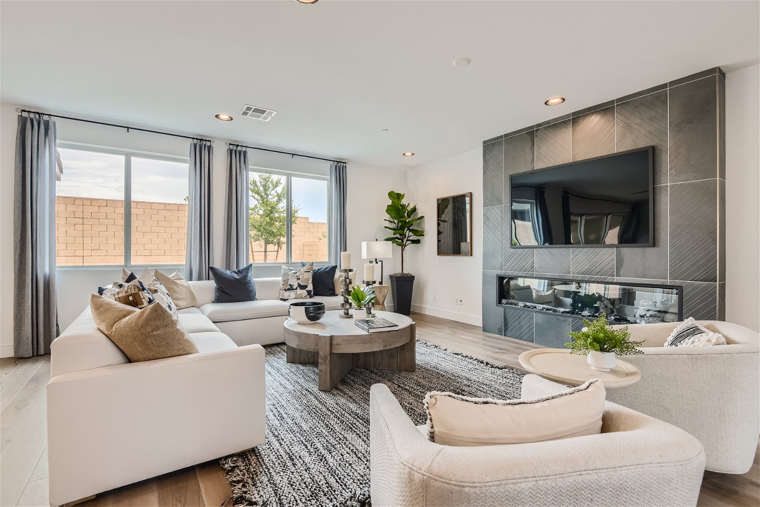 A living room with a large tv and couches.
