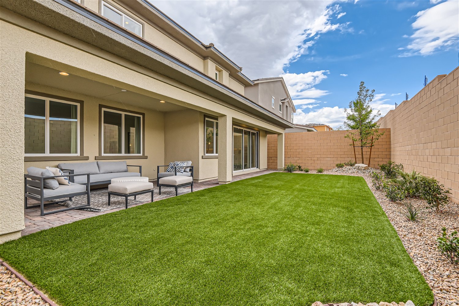 A house with a lawn and chairs.