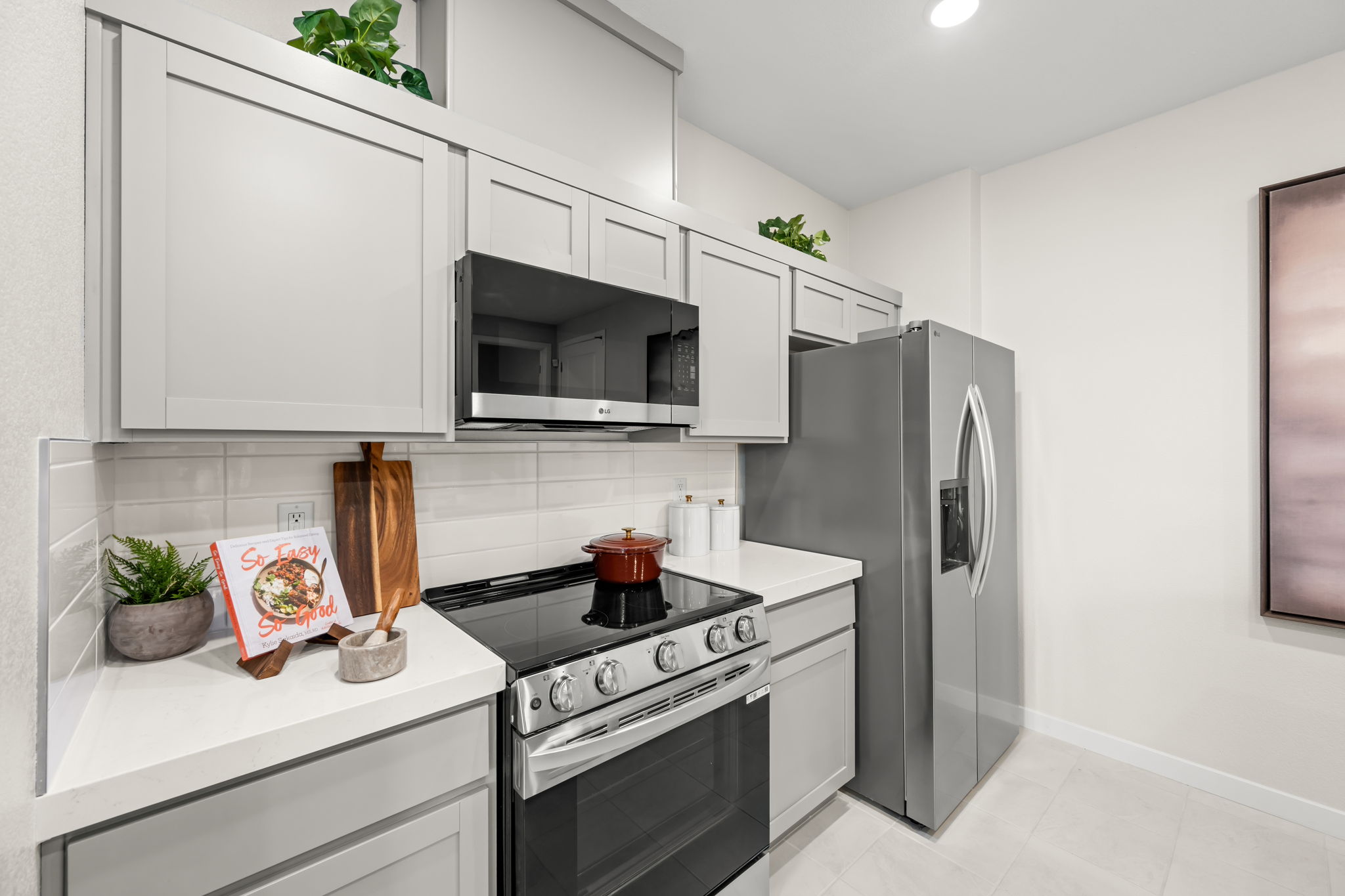 A kitchen with white cabinets.