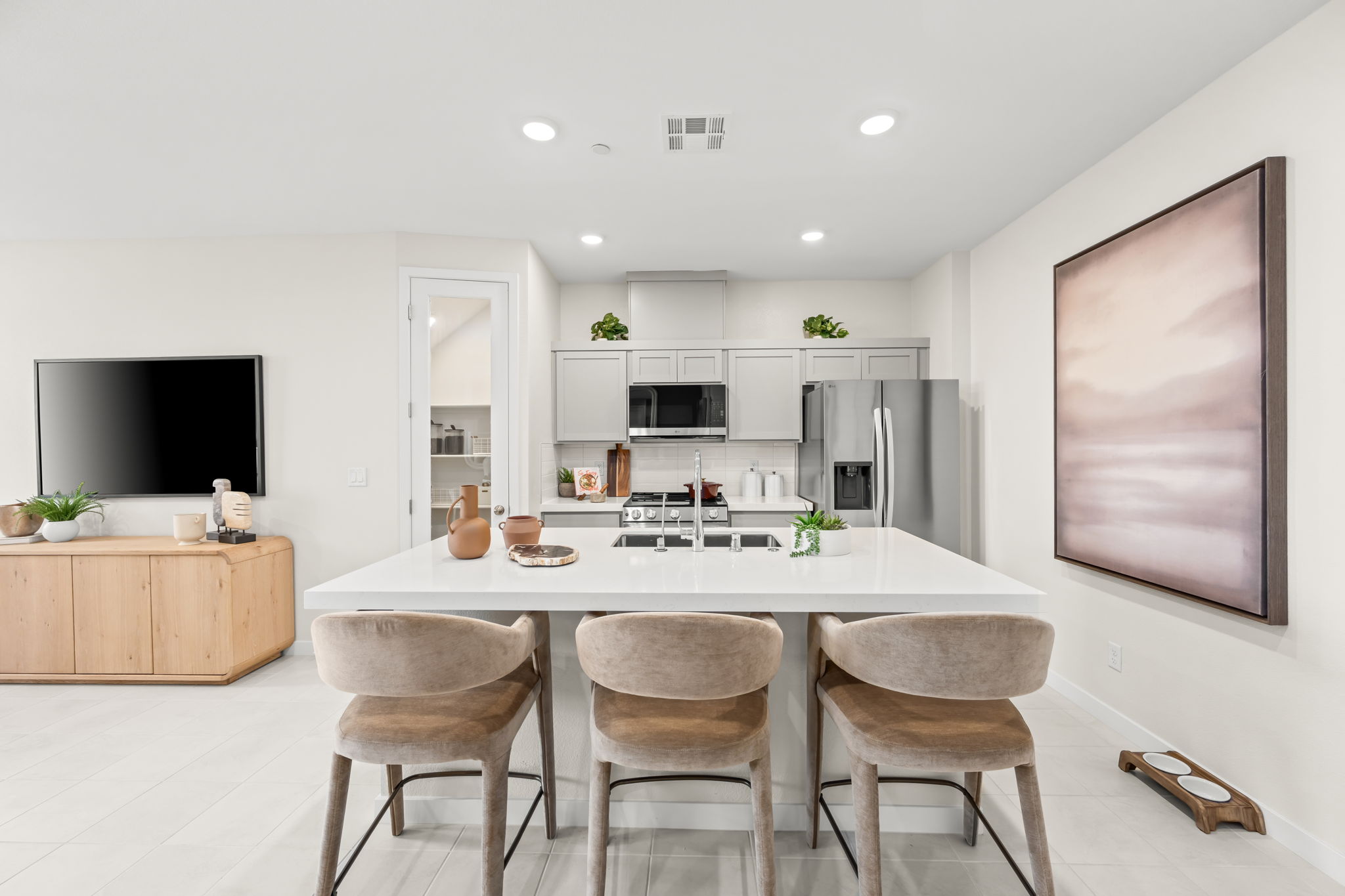 A kitchen with a table and chairs.