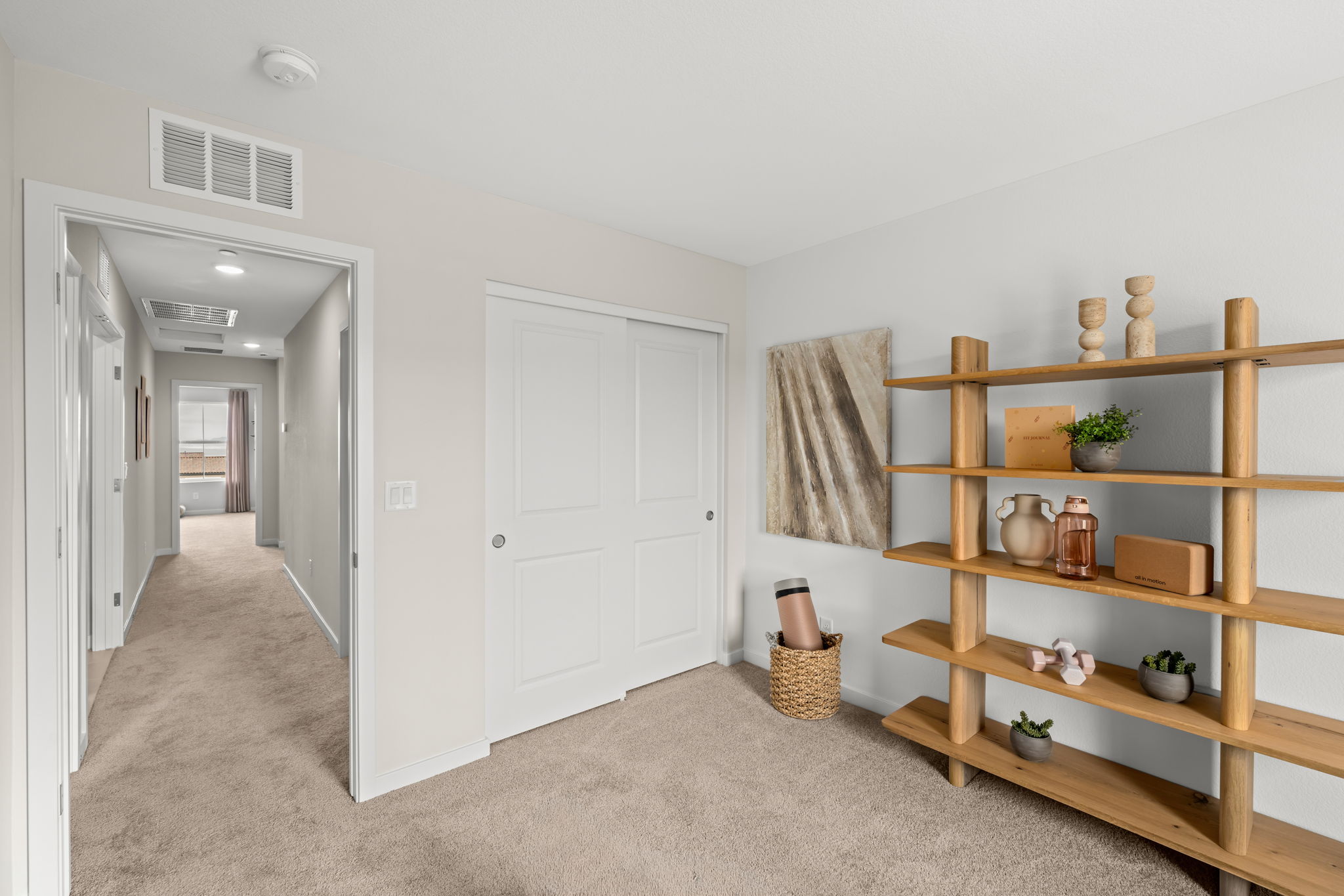 A room with a shelf and a door.