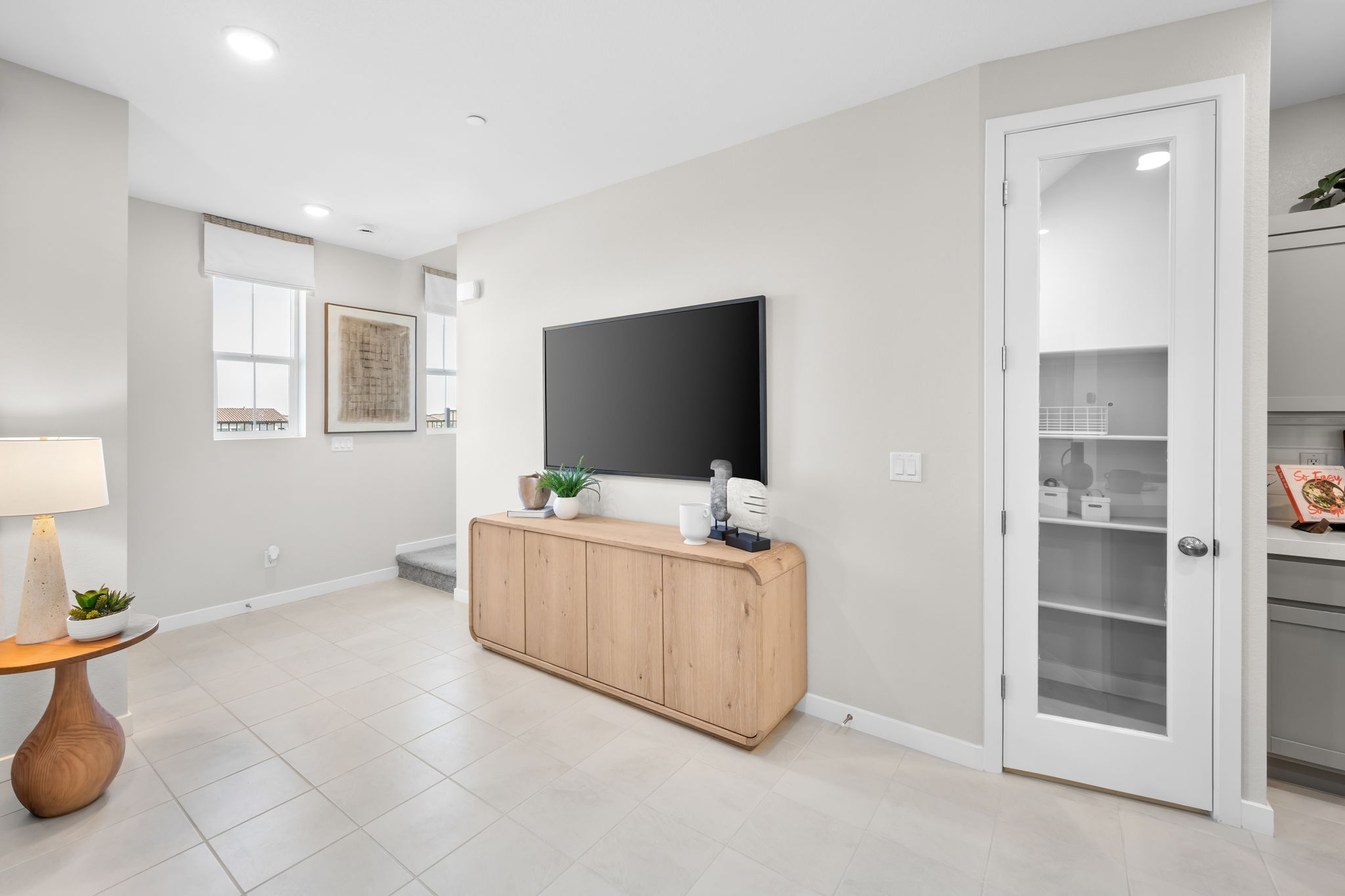 A room with a tv and a cabinet.