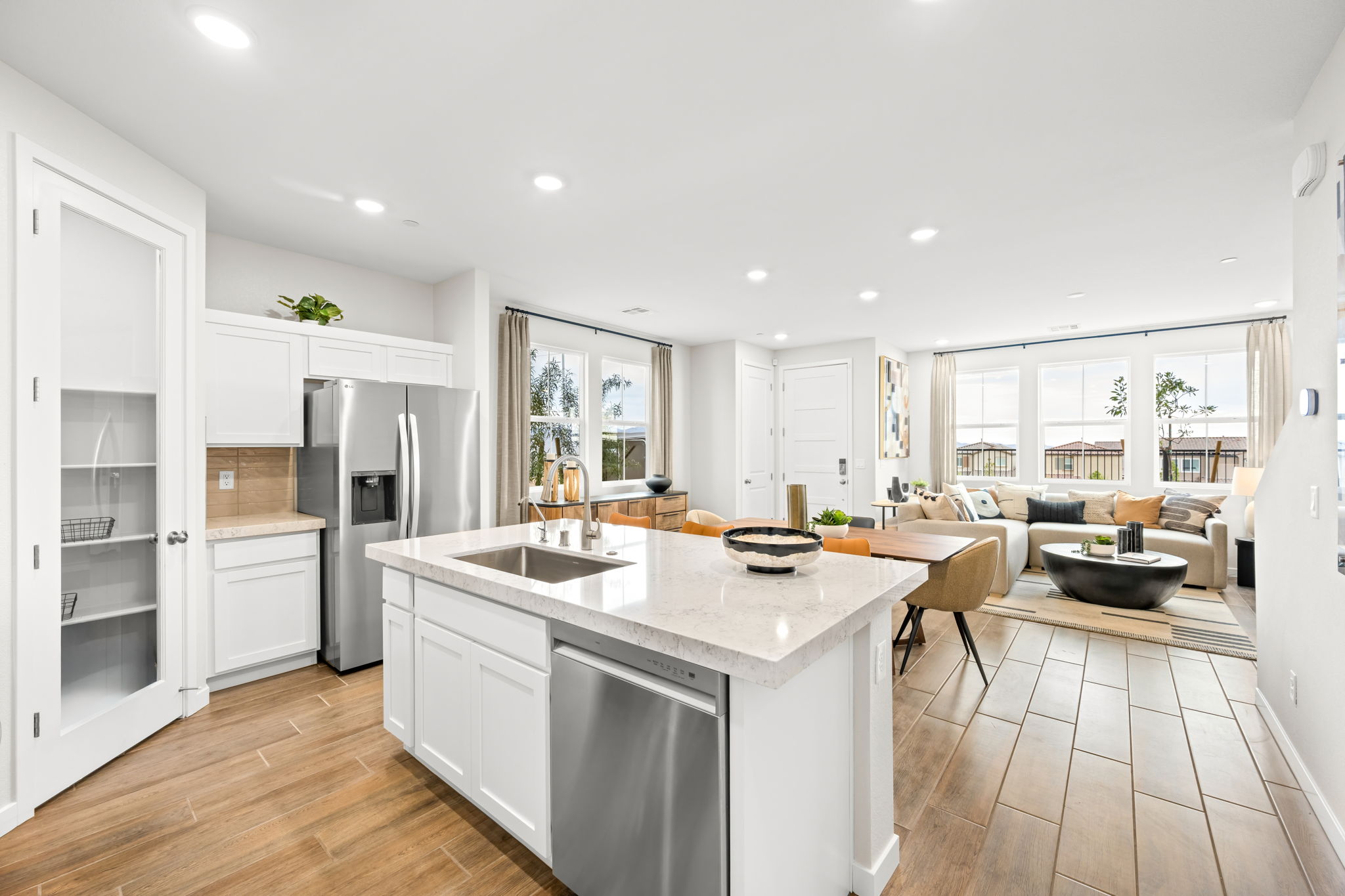 A kitchen with white cabinets.
