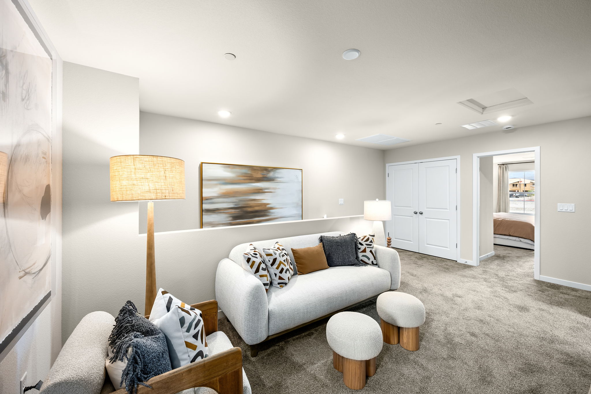 A living room with a couch and a lamp.