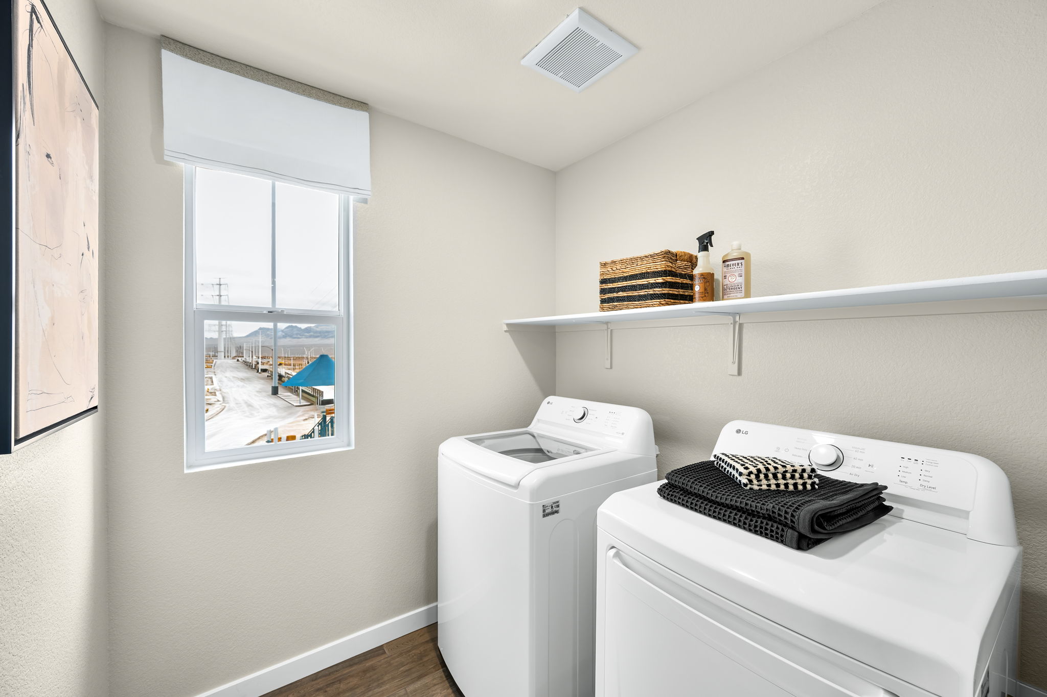 A laundry room with a washing machine.