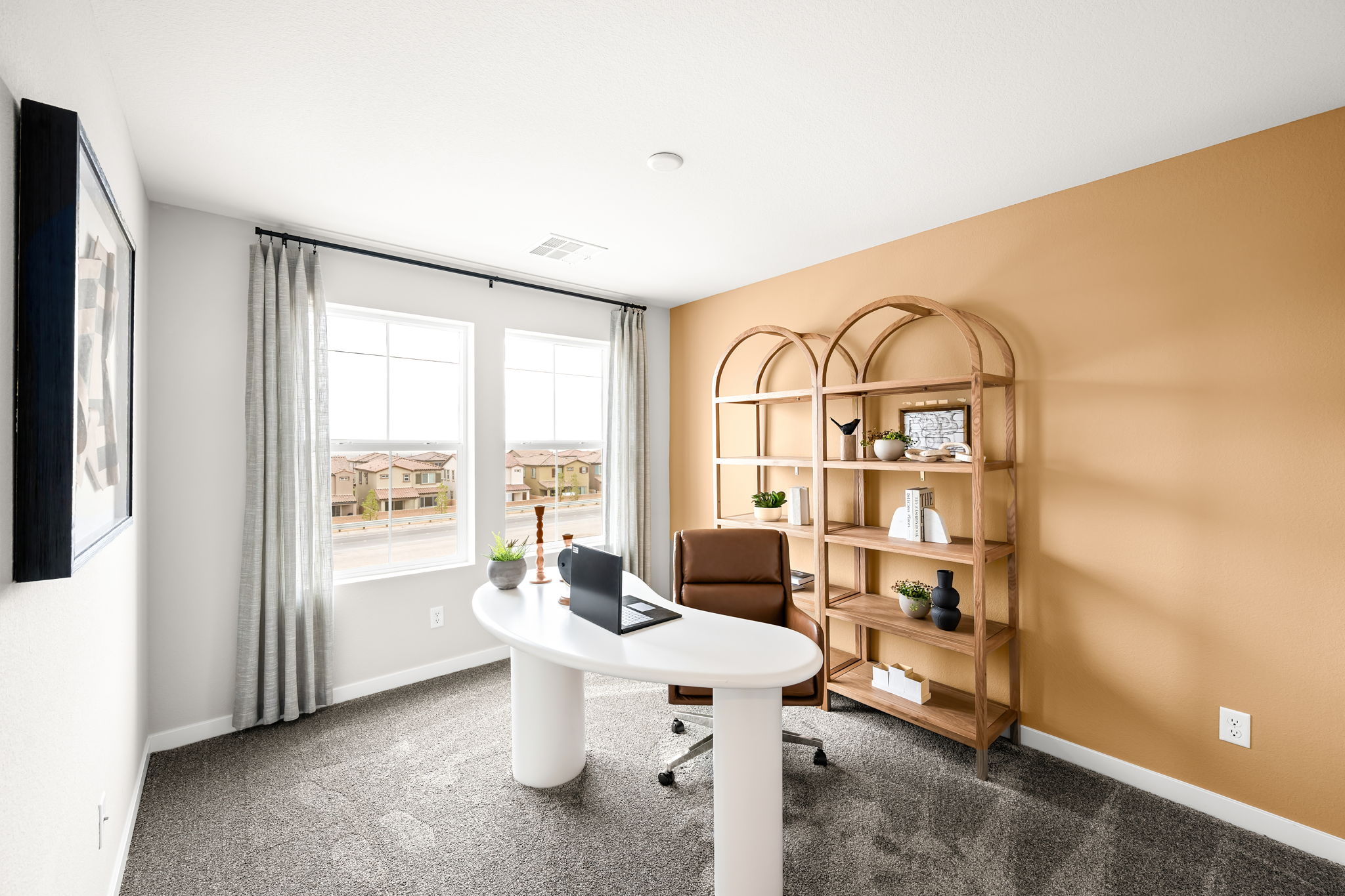 A room with a desk and a window.