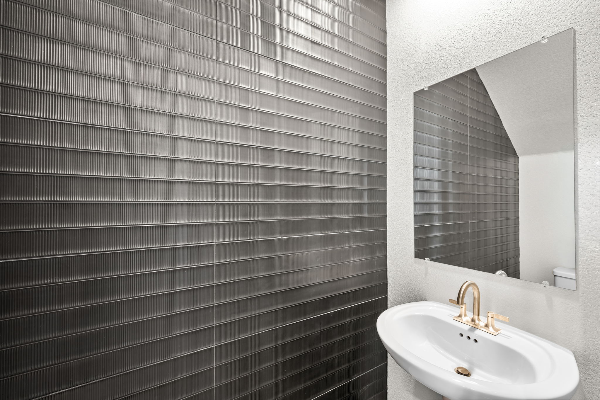 A bathroom with a mirror and a sink.