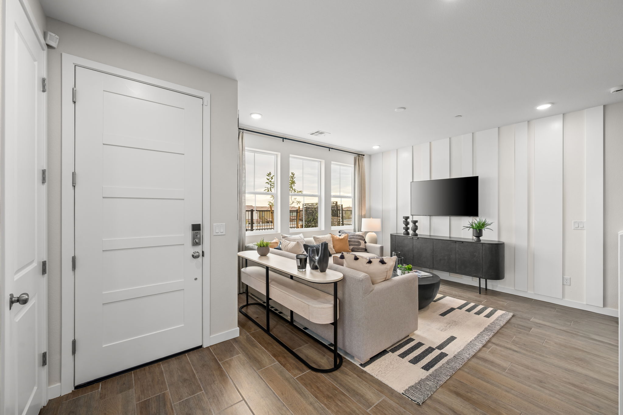 A living room with a large glass door and a large white couch.