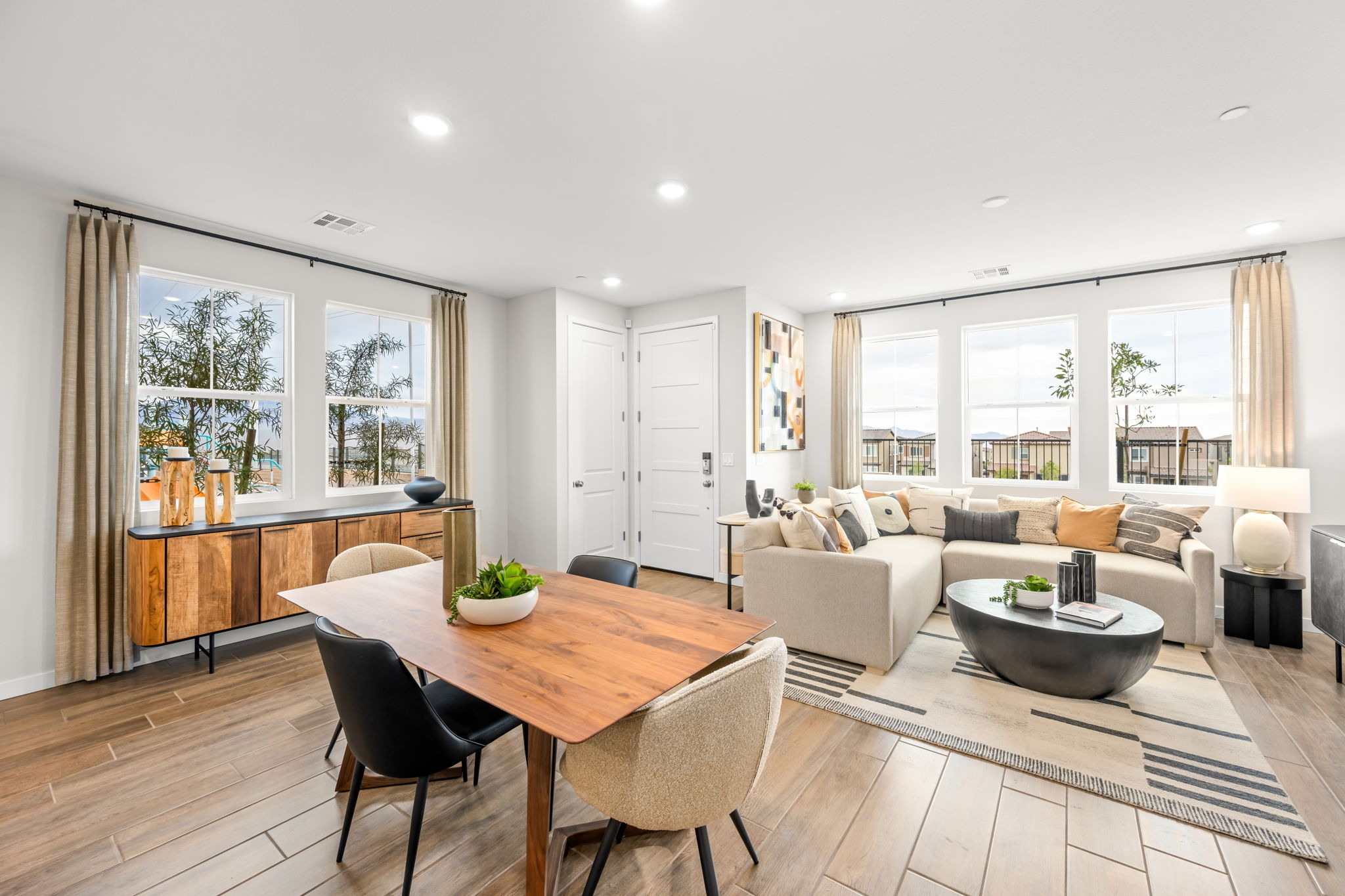 A large living room with a large table and chairs.