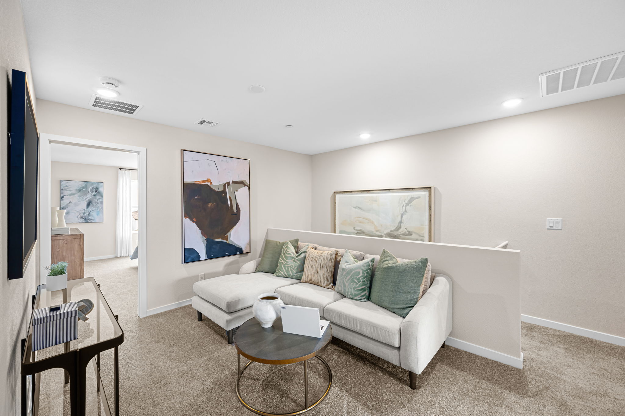 A living room with a white couch and a coffee table.