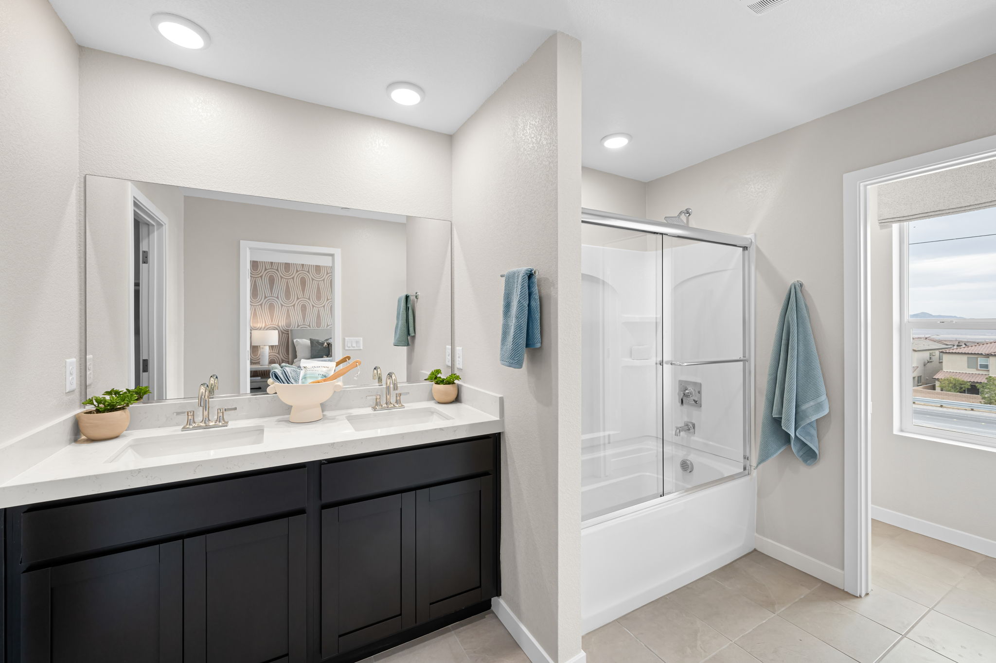 A bathroom with a sink and a shower unit.