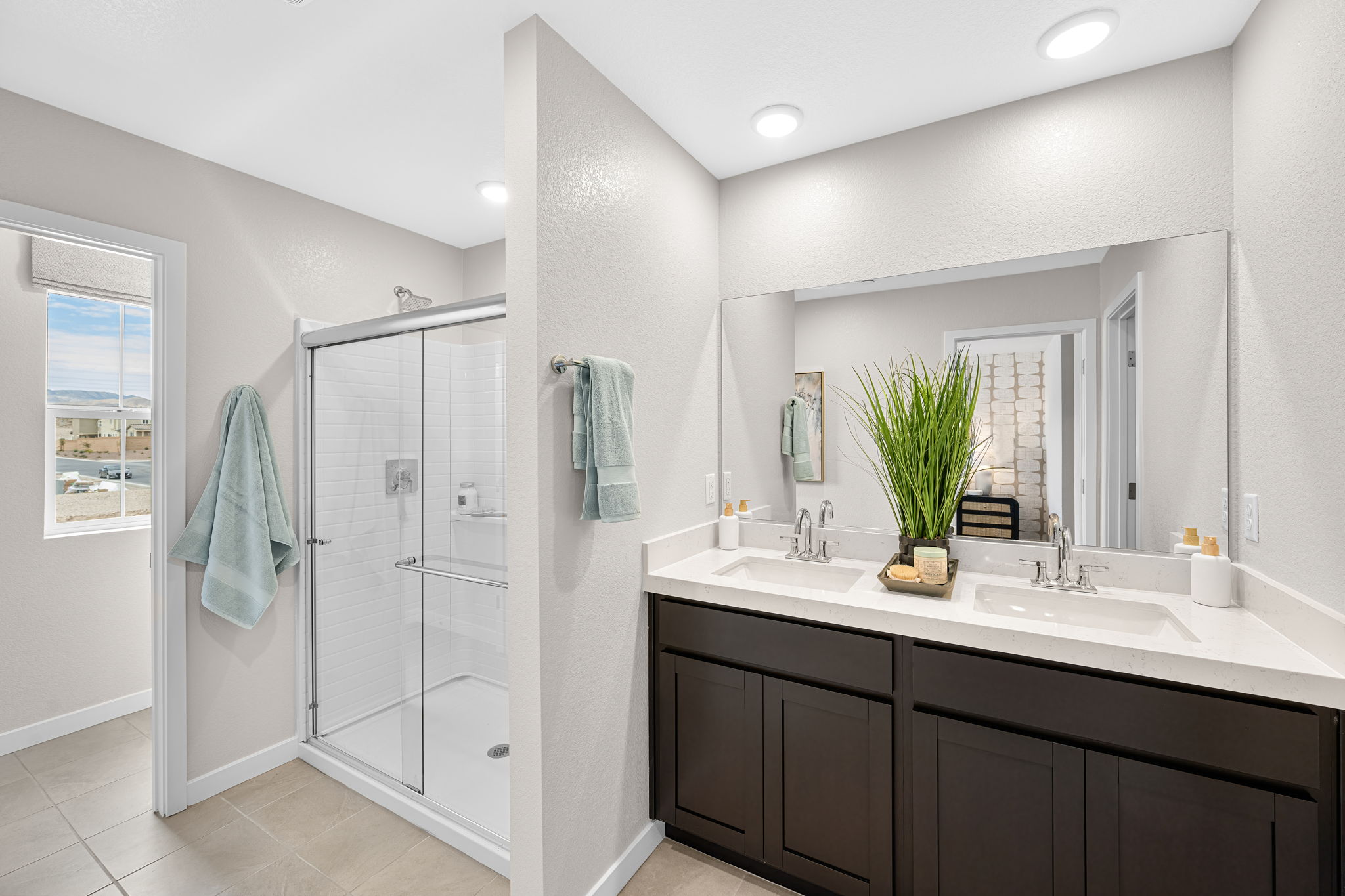 A bathroom with a sink and a shower.