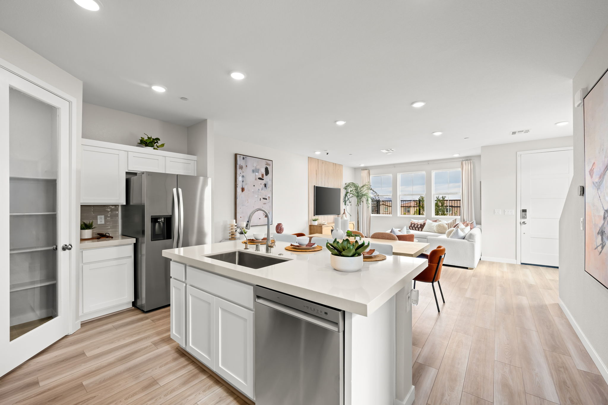 A kitchen with white cabinets.