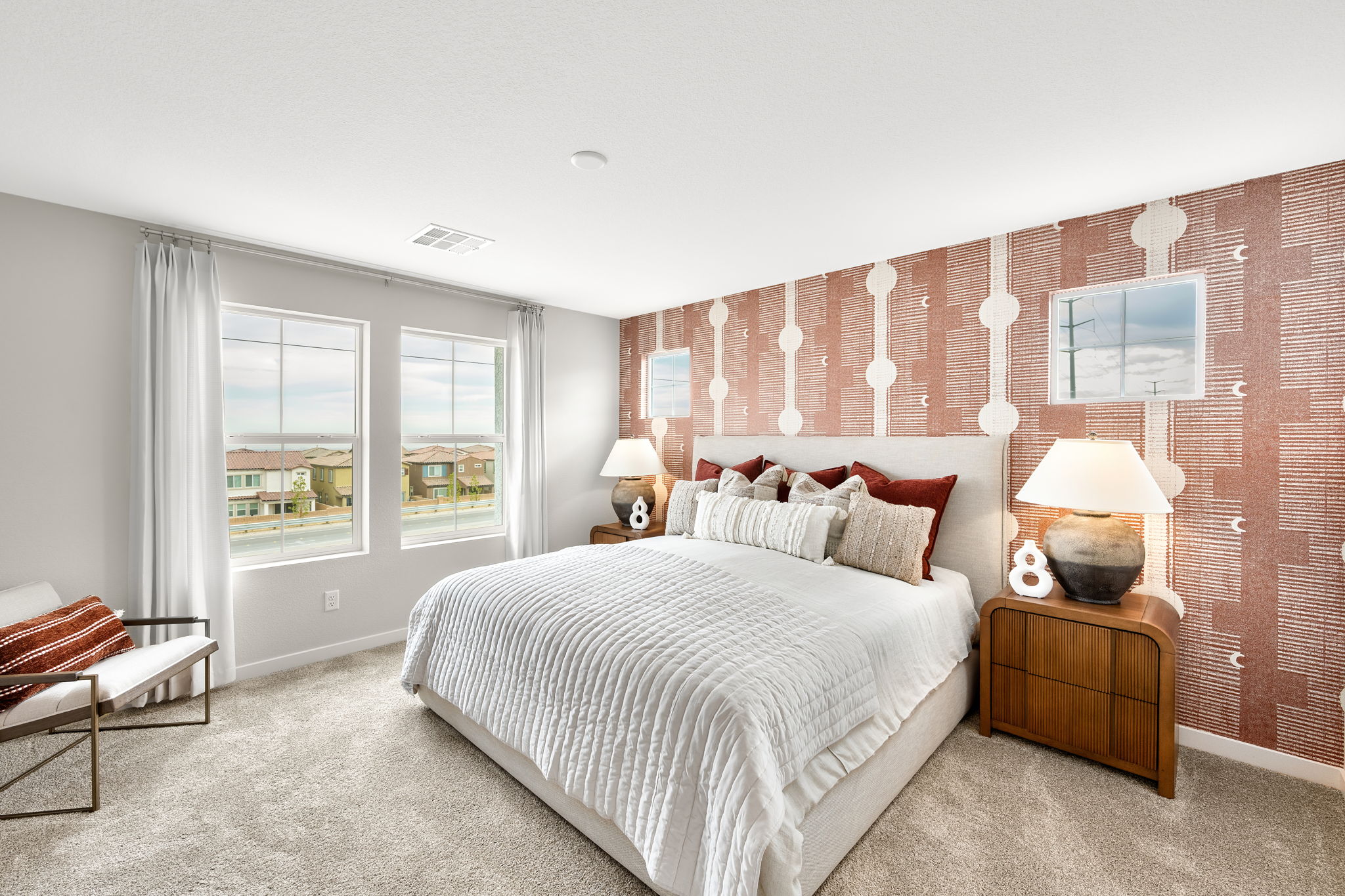 A bedroom with a bed and a bench.