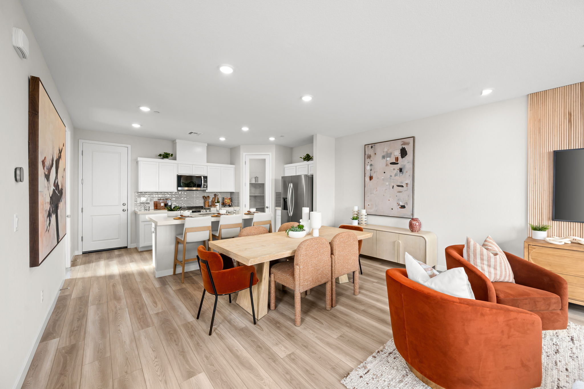 A large kitchen with a dining table.
