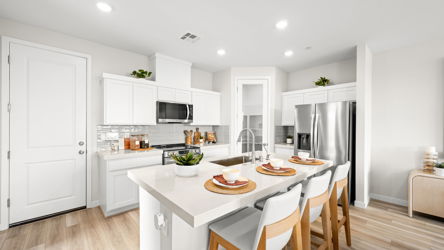 A kitchen with white cabinets.