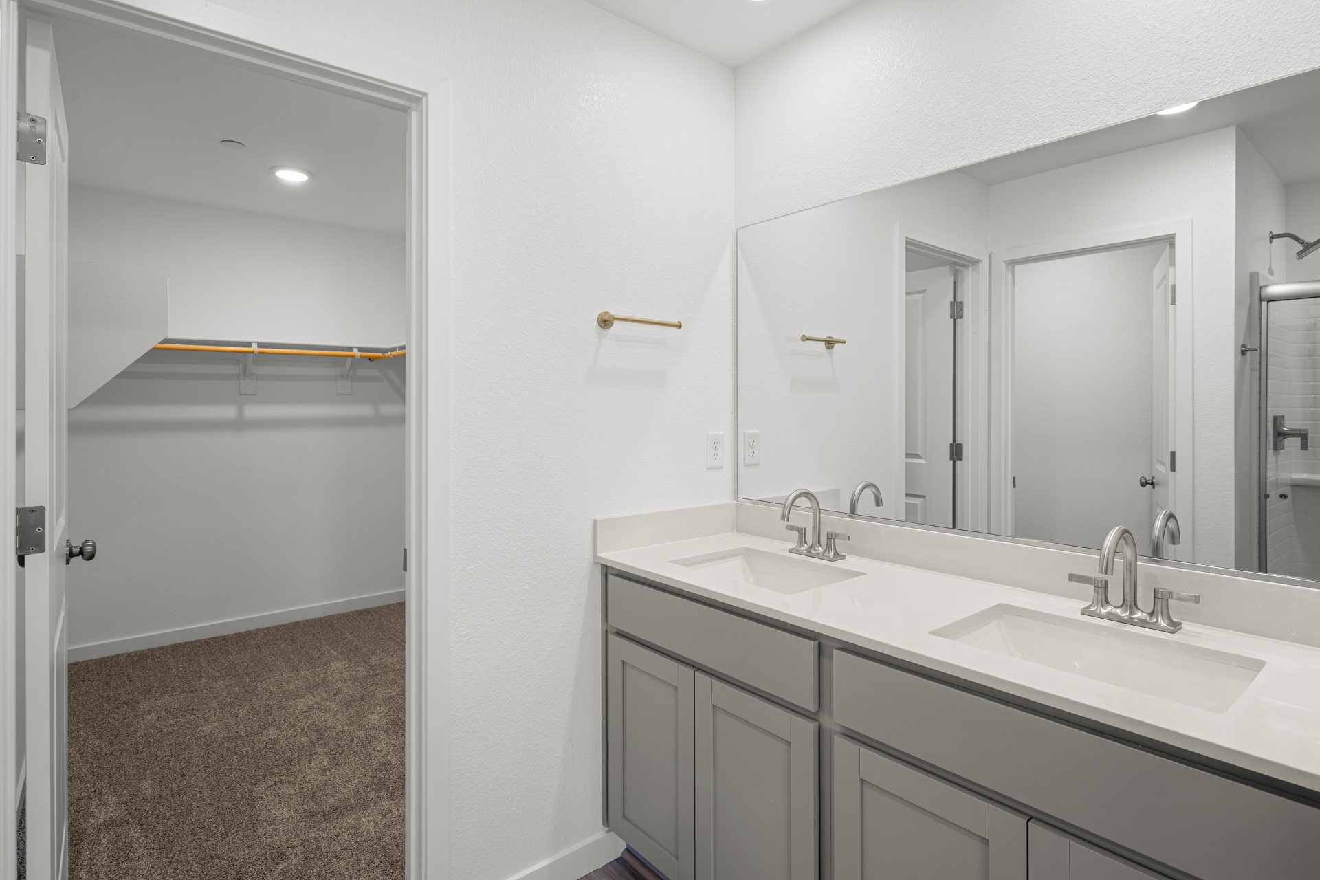 A bathroom with a large mirror.