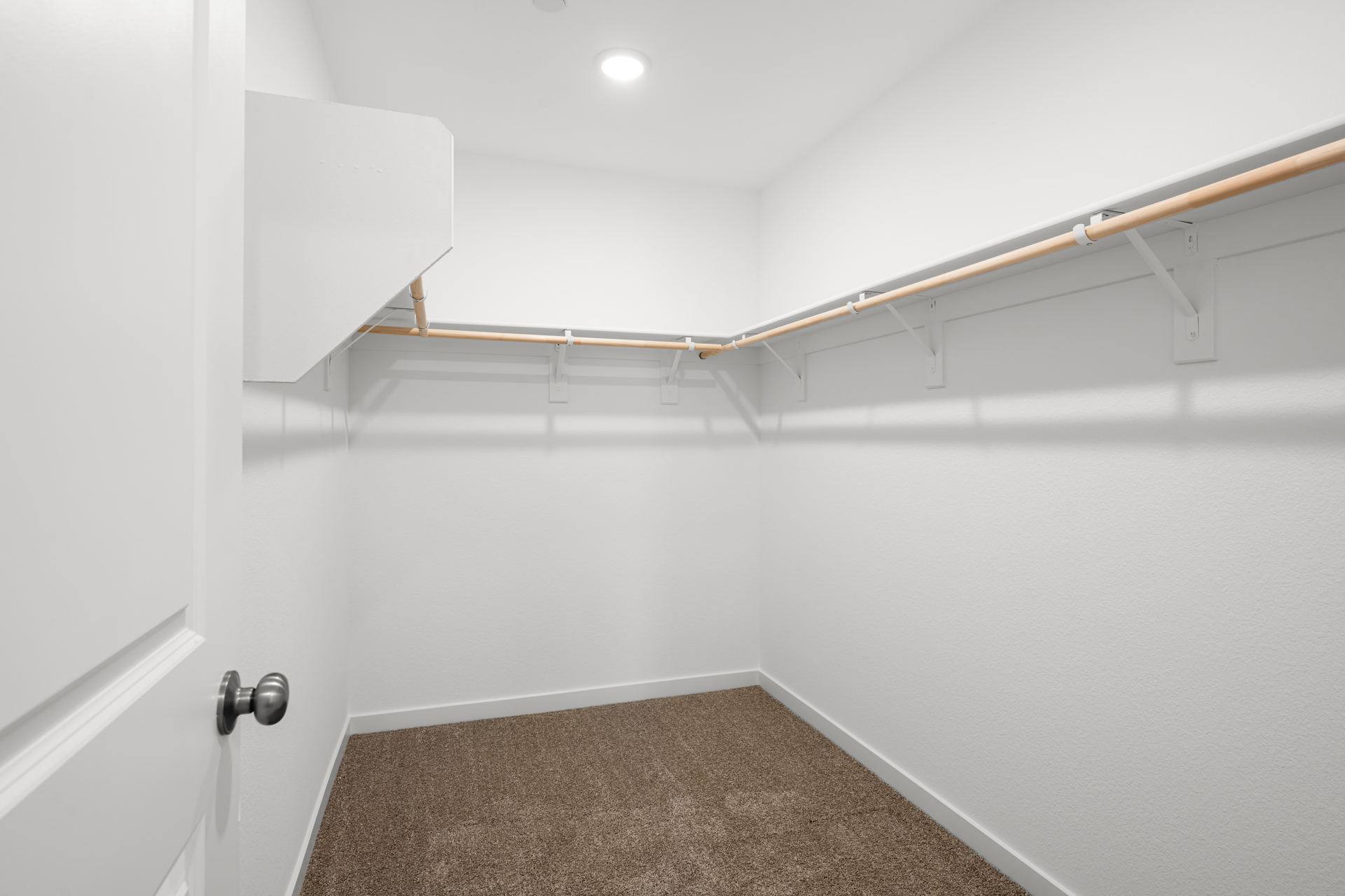 A white room with a metal bar.