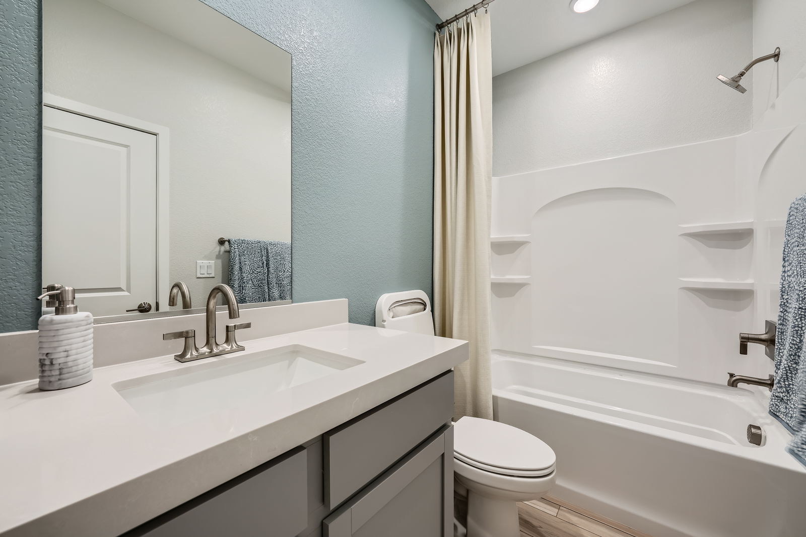 A bathroom with a tub sink and toilet.