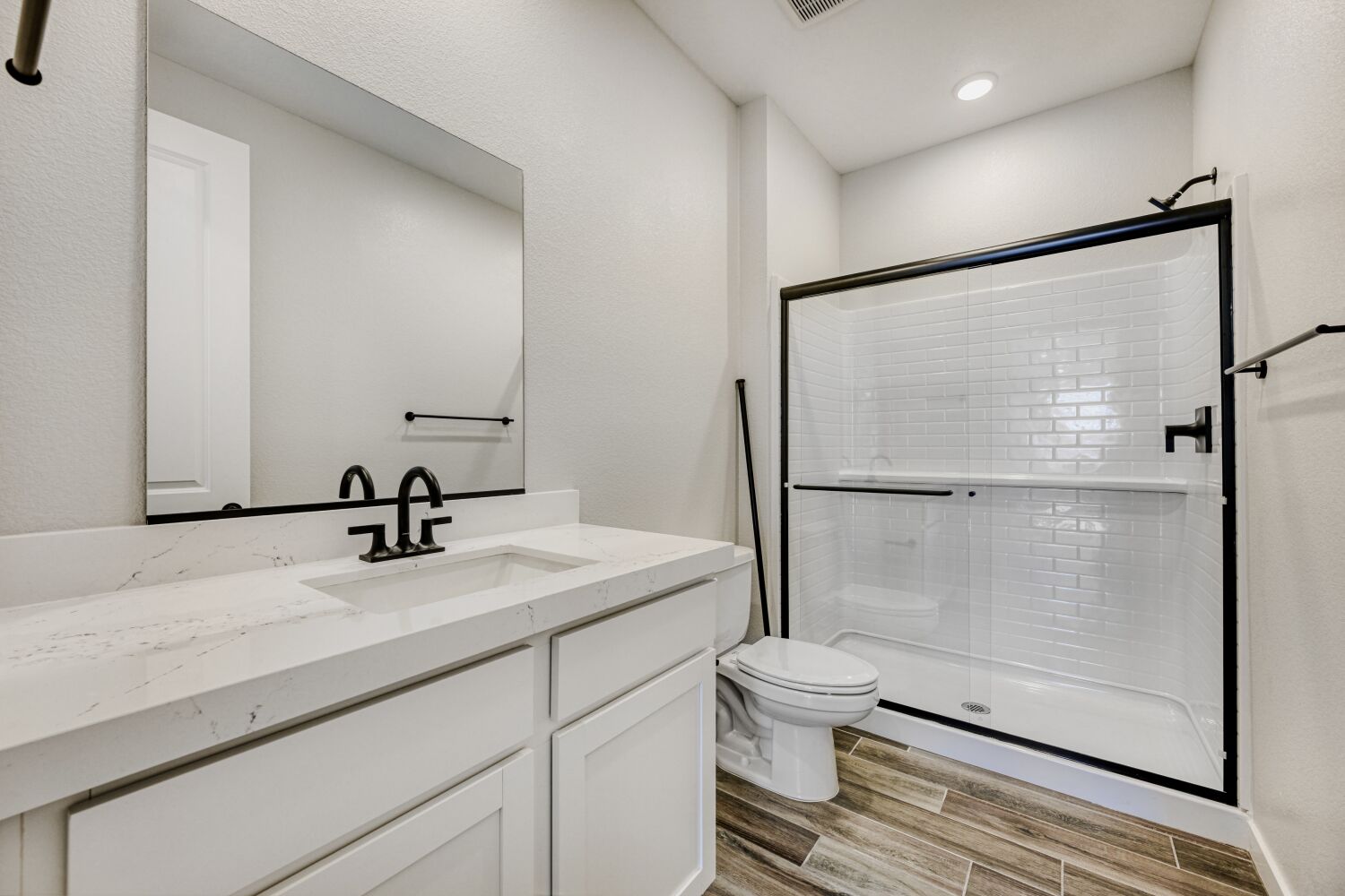 A bathroom with a shower and sink.