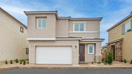 A white house with a garage.