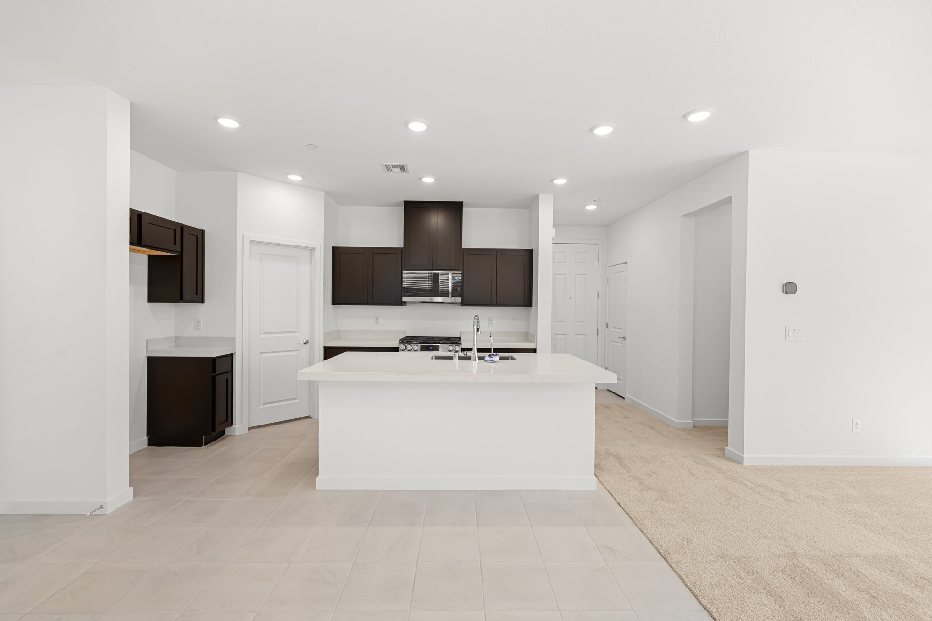 A large white kitchen with a white counter top and a white counter top.