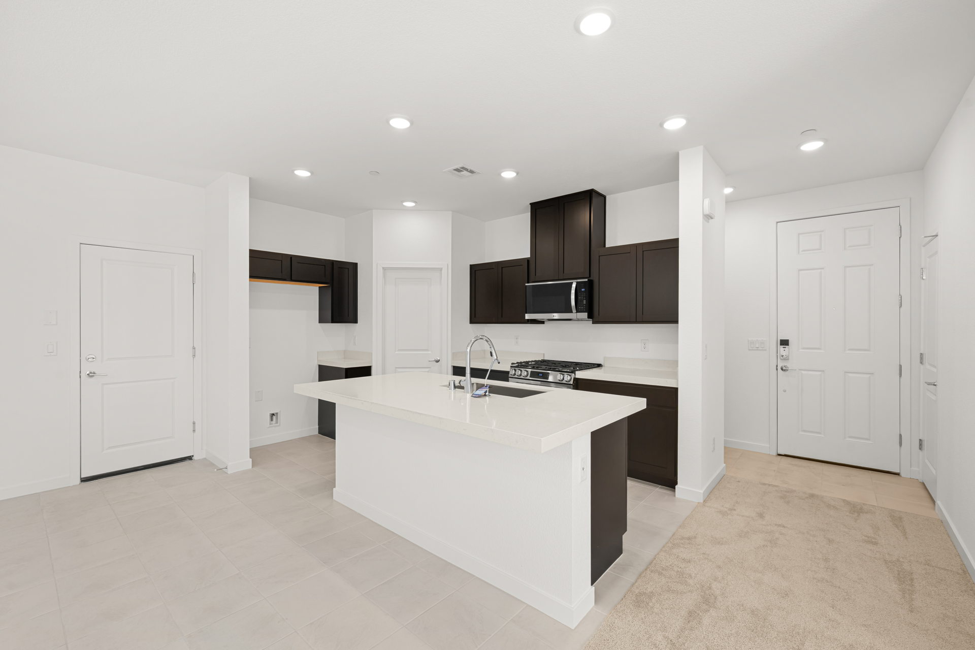 A kitchen with white cabinets.